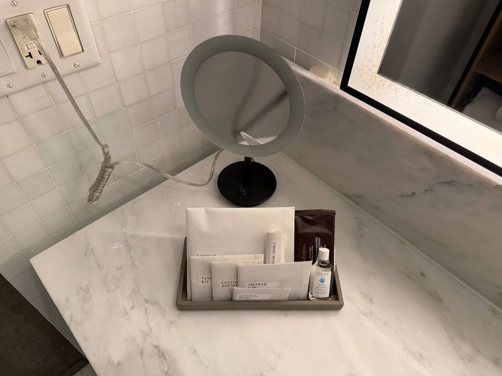 the-london-nyc-one-bedroom-suite-bathroom-amenity-tray-vanity-mirror