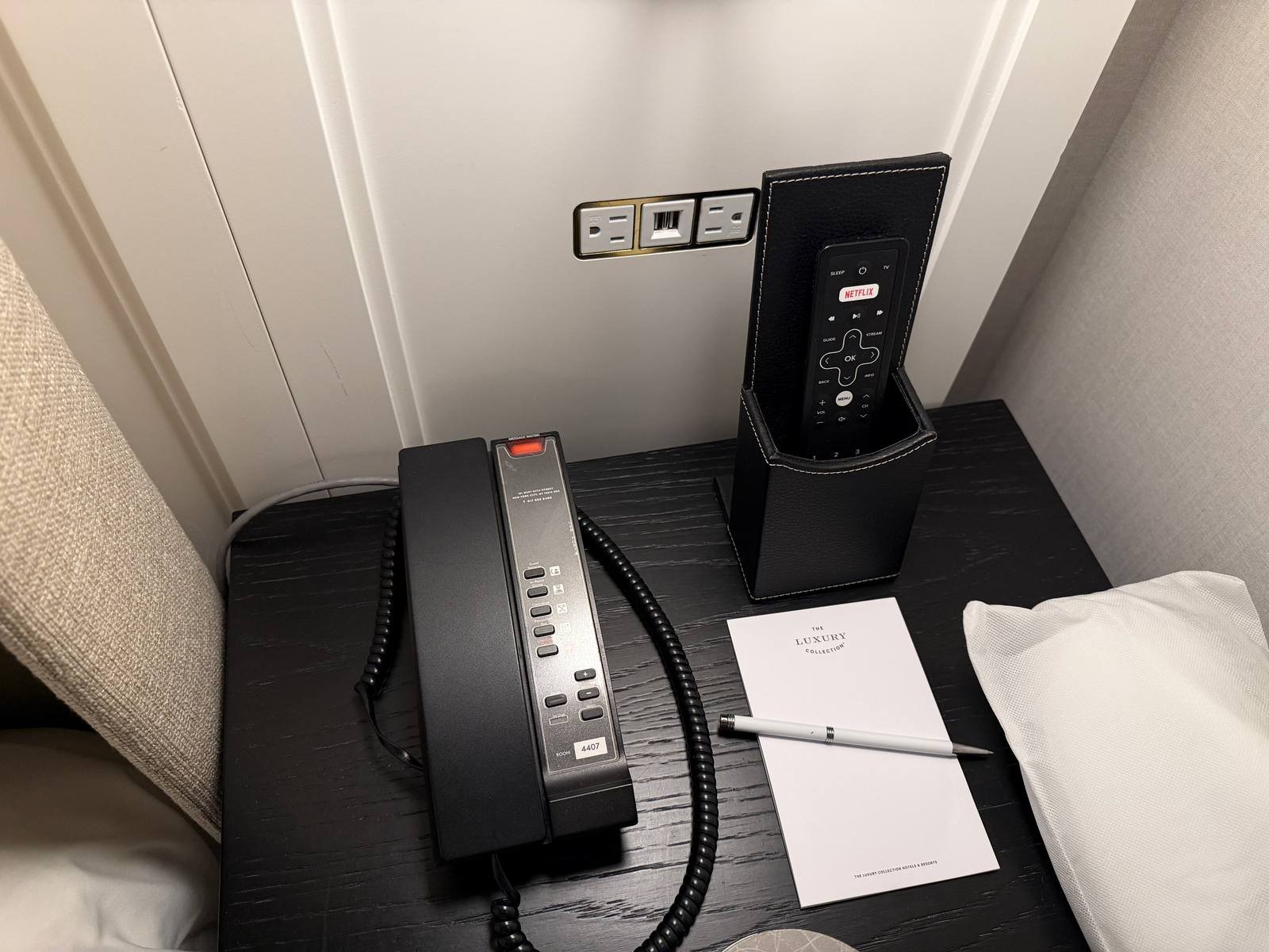 the-london-nyc-one-bedroom-suite-nightstand-phone-tv-remote