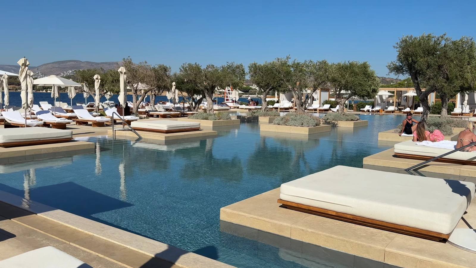 four-seasons-astir-palace-athens-pool-floating-daybeds-olive-trees