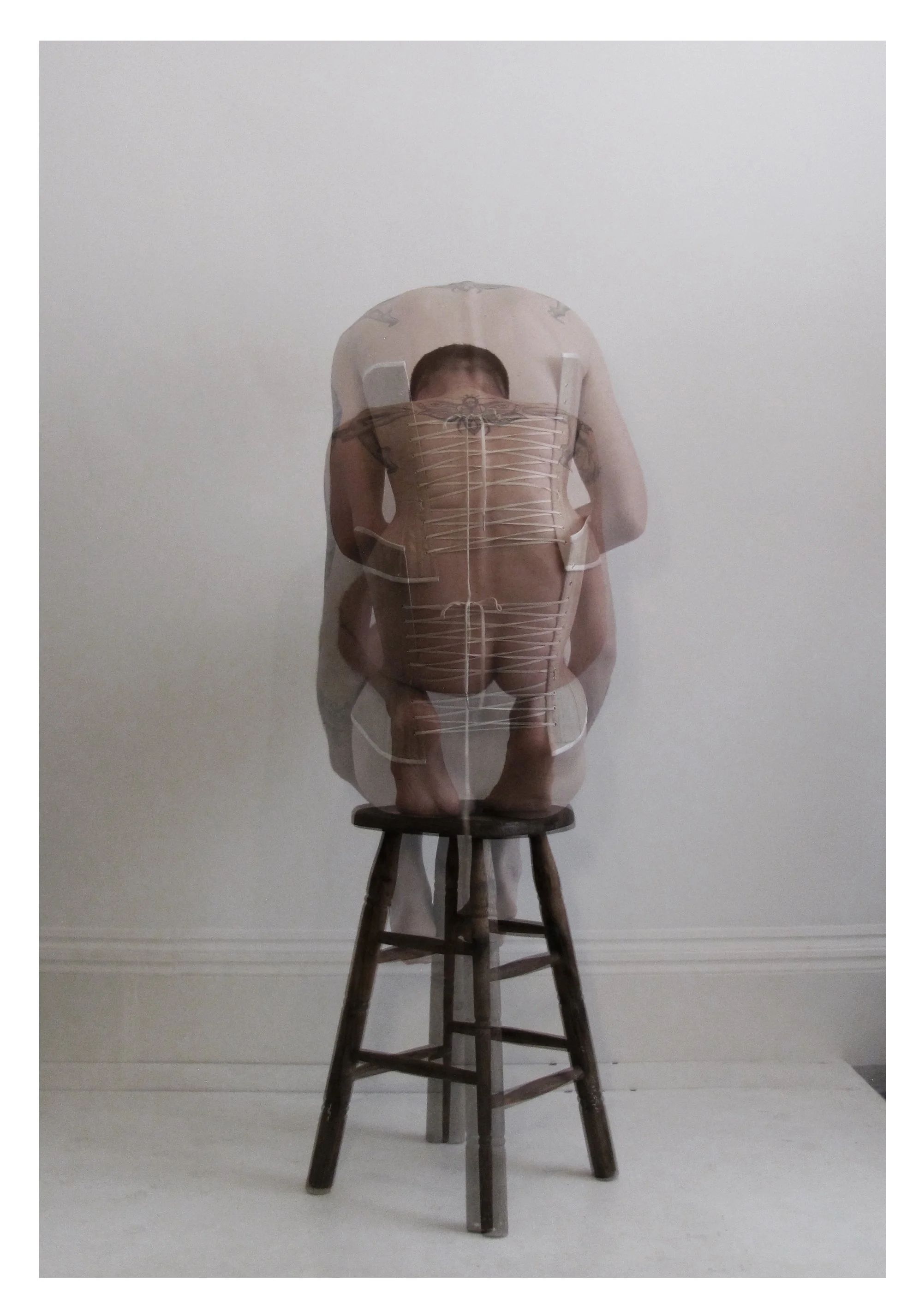 Abstract image of a person with a superimposed corset design, sitting on a wooden stool against a plain background.