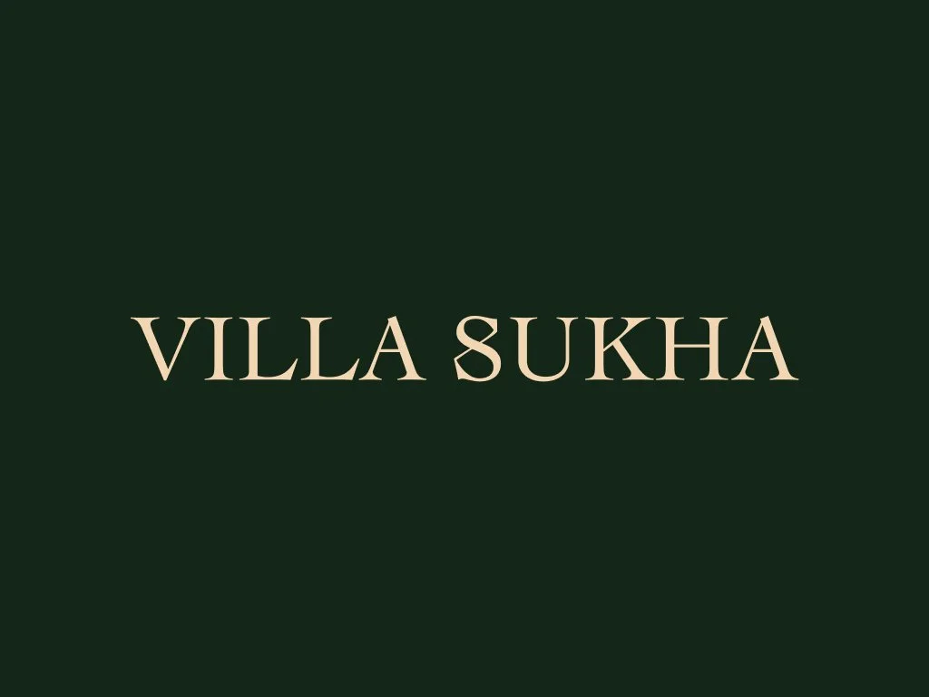 Text on a dark green background reading 'VILLA SUKHA' in beige letters.