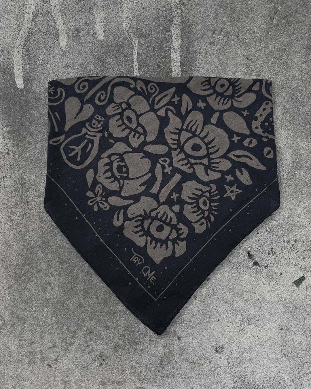 Poisoner’s Garden bandana in midnight black, folded into a triangle on concrete background.