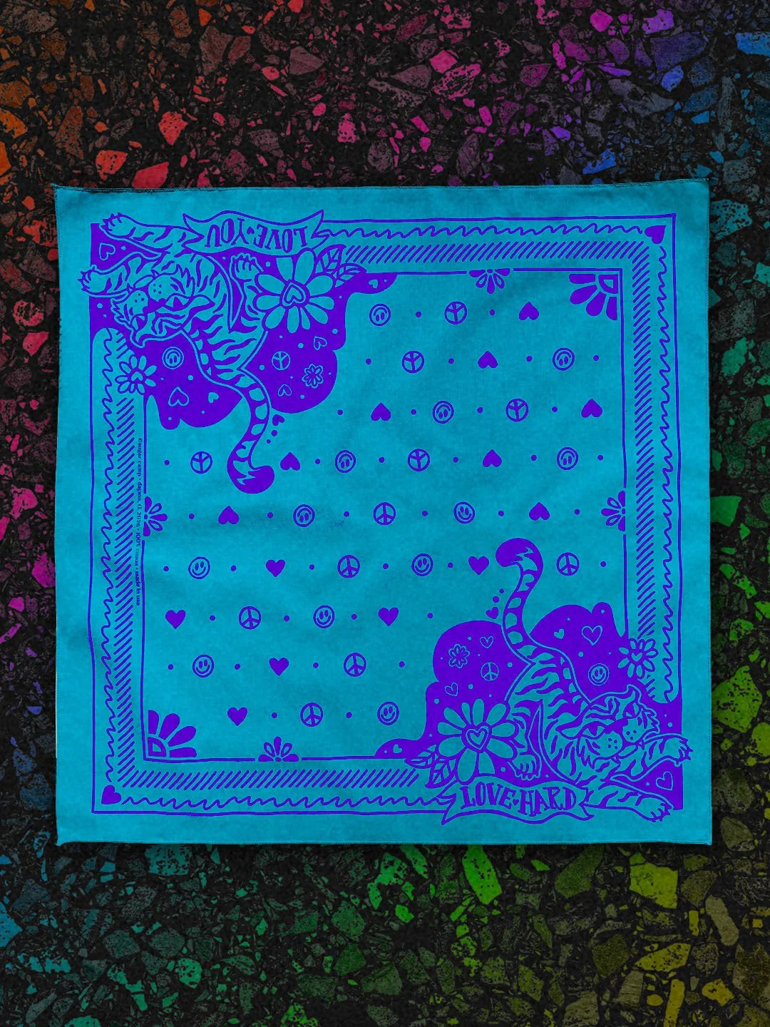 Love Hard Bandana by Sugar Camp in Turquoise w/ cobalt ink, laid flat on a black rainbow terrazzo background. Features sweet, fierce tiger, hearts, smileys, and peace signs.