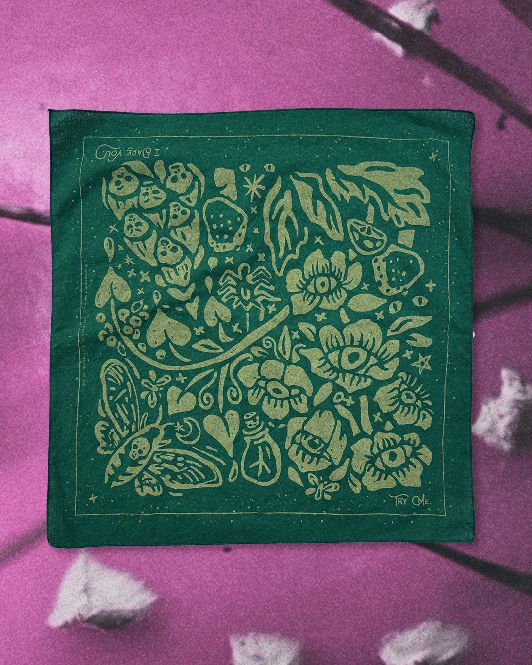 Poisoner’s Garden bandana in moss green, laid flat against a hot purple-pink botanical mushroom background.