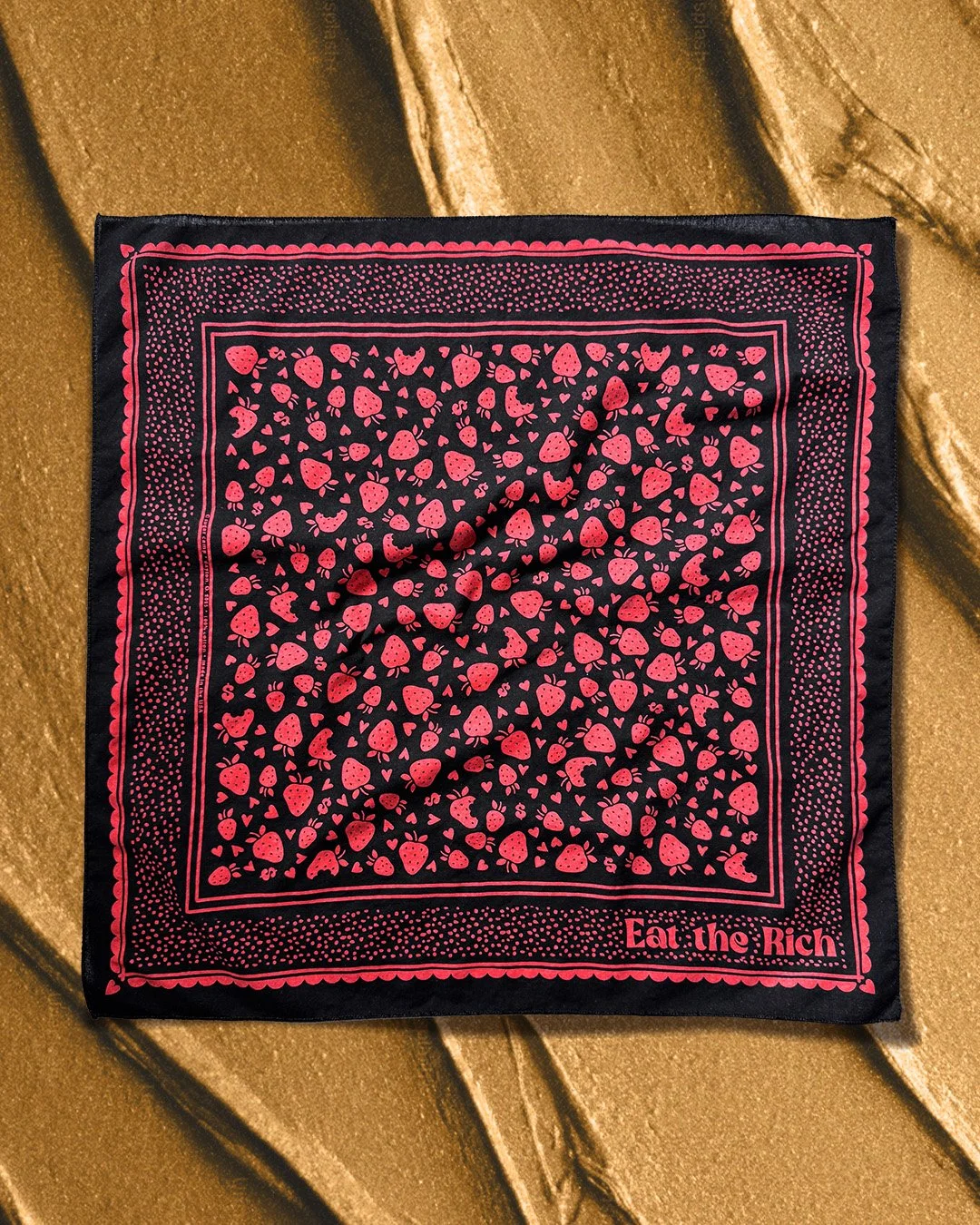 Black “Eat the Rich” bandana with red strawberry, heart, and dollar sign pattern on gold frosting background