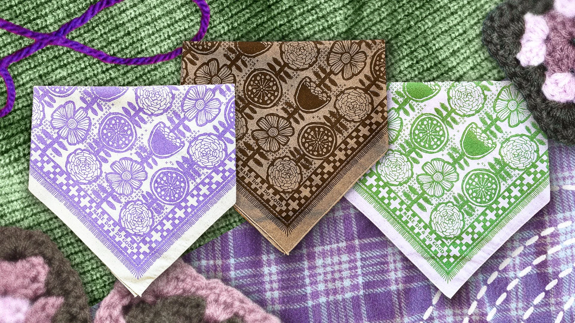 Sugar Camp bandanas in sprout green, lilac purple & mushroom brown, features hand-drawn Scandinavian florals & stitches, reads “Make do & Do Good.” staged with with yarn and granny squares