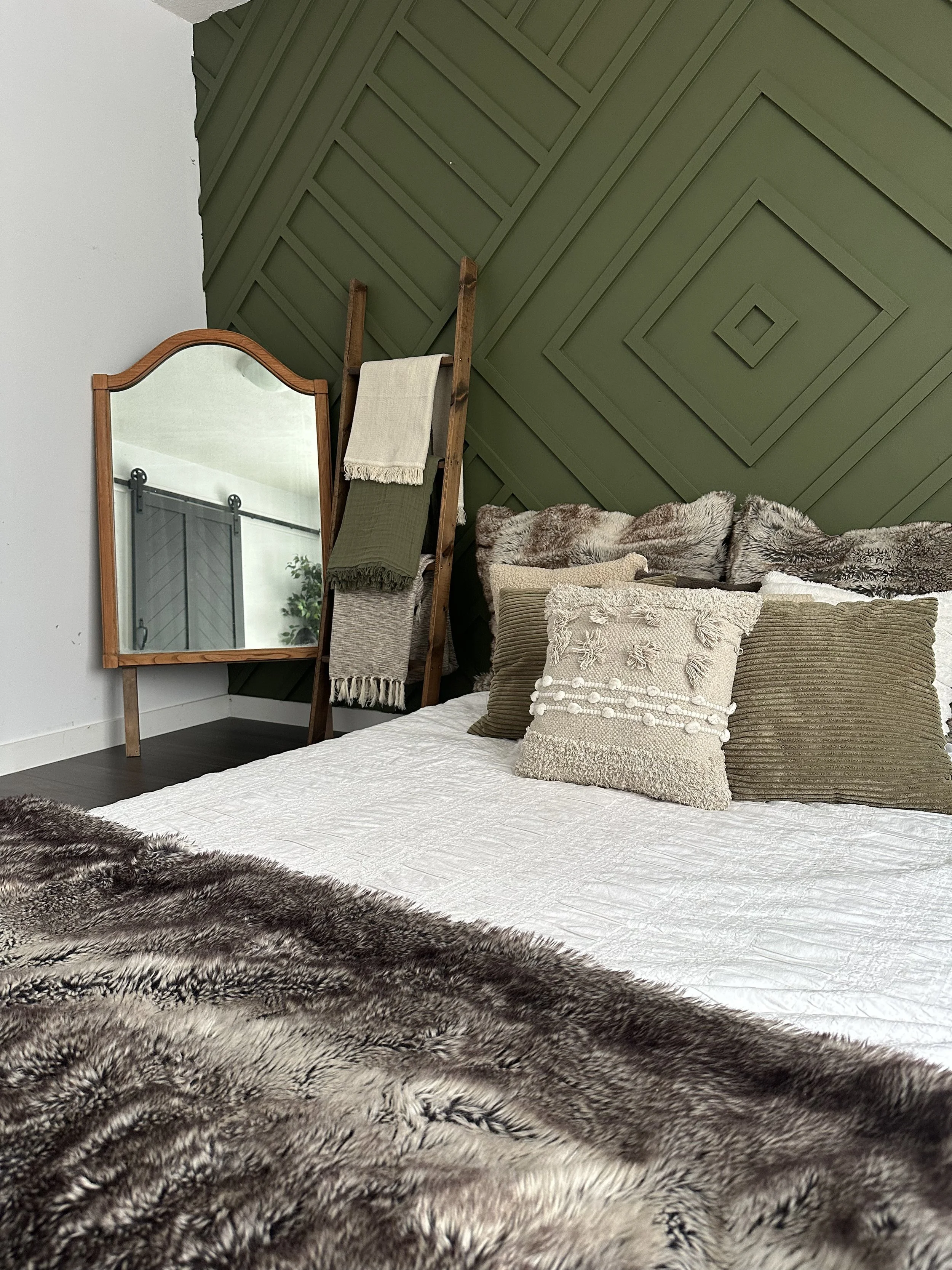 Edmonton photography studio offering a cozy bedroom set with soft pillows and abundant natural light.