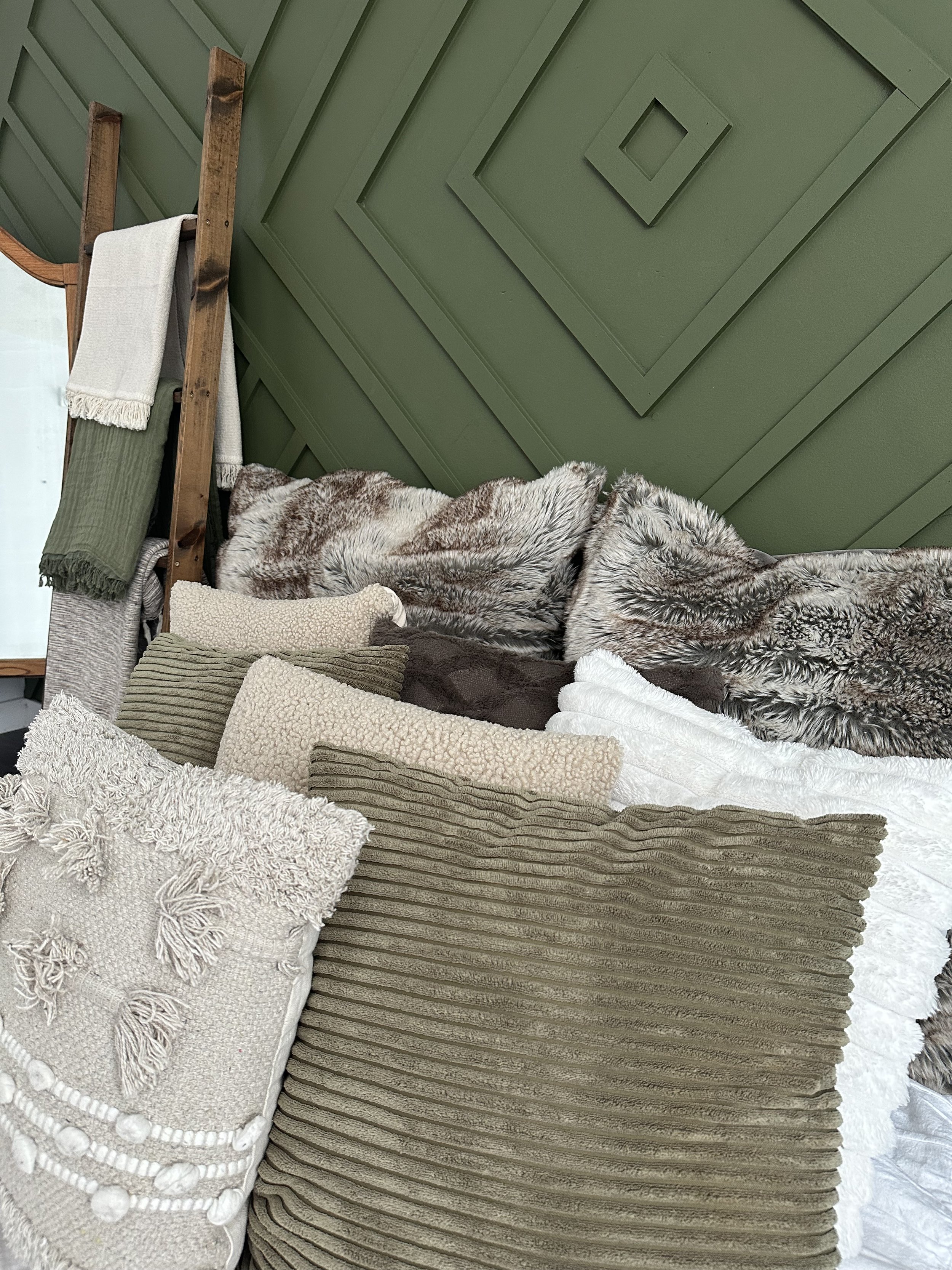 Cozy Edmonton photography set with plush bedding and comfortable armchair for intimate photoshoots.