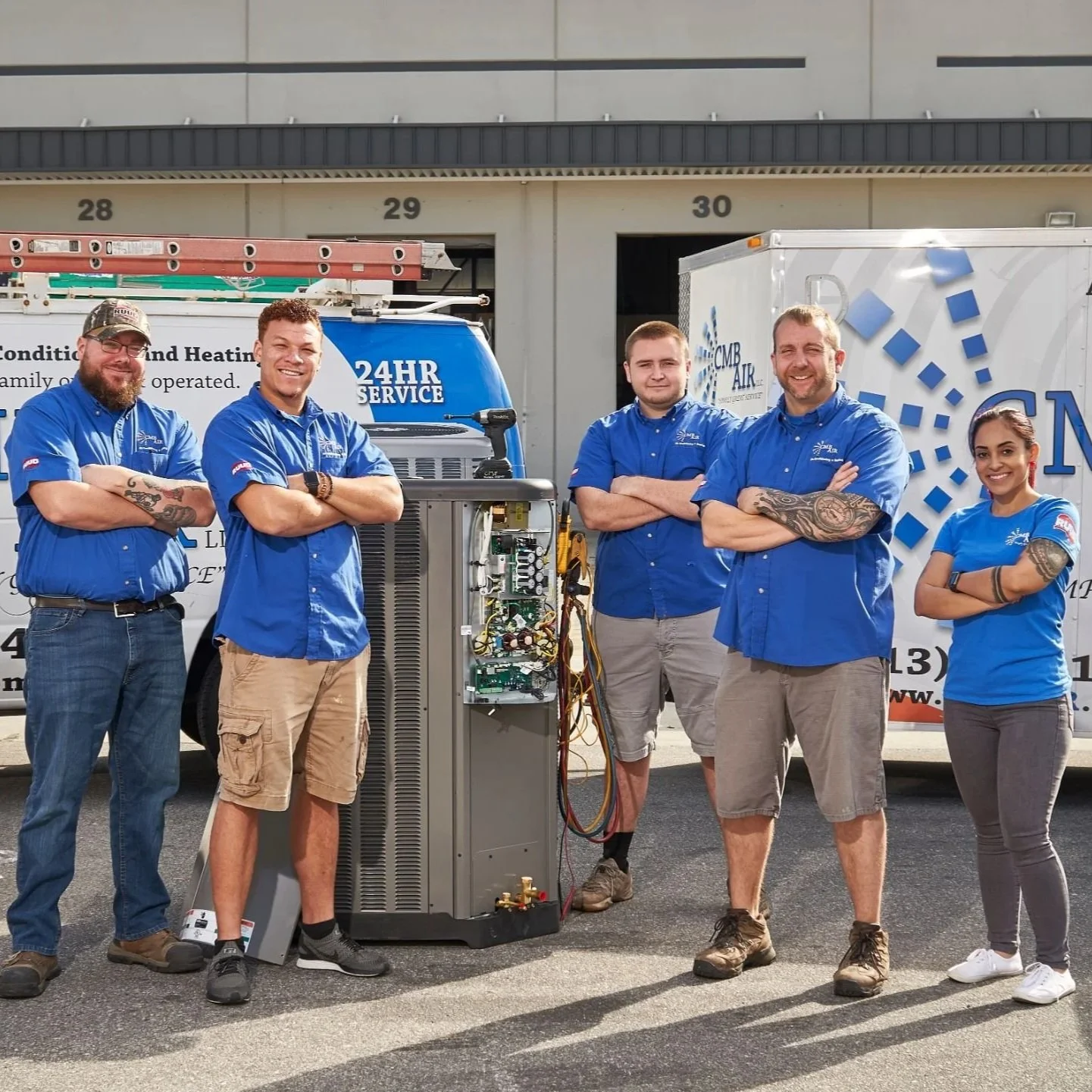 A technician inspecting an old air conditioning unit in a home attic to determine if the AC system needs replacement.