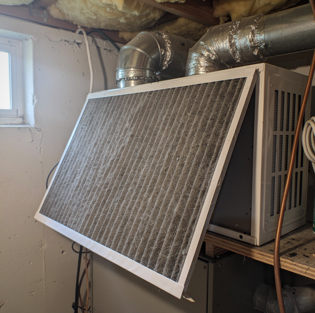 central air conditioner condenser unit running in summer heat