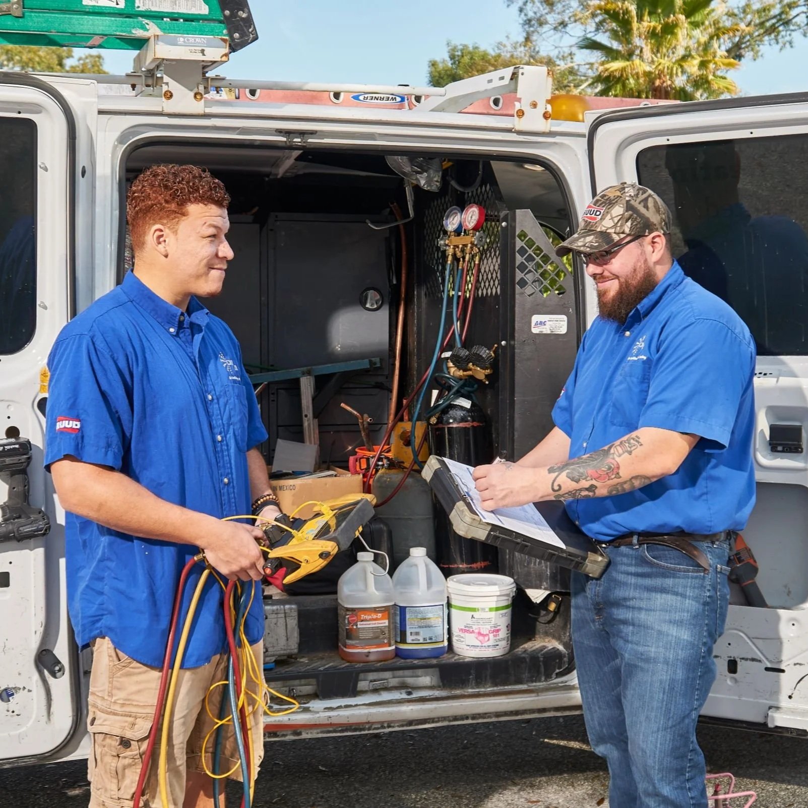 Air conditioning technician installing a new energy-efficient AC unit for a Tampa homeowner seeking rebates and financing options.