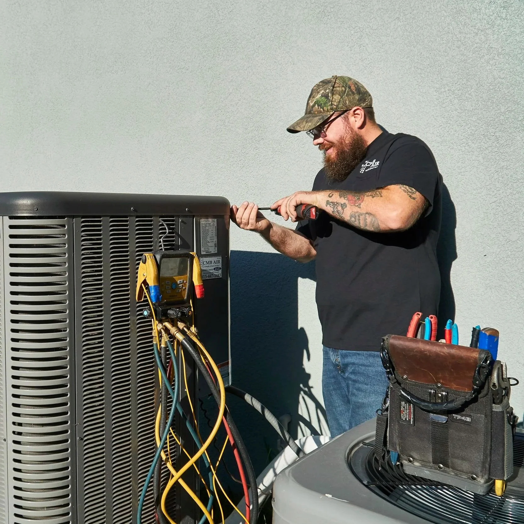 Technicians installing a new AC system in a Tampa home, preparing the workspace and removing the old unit safely.