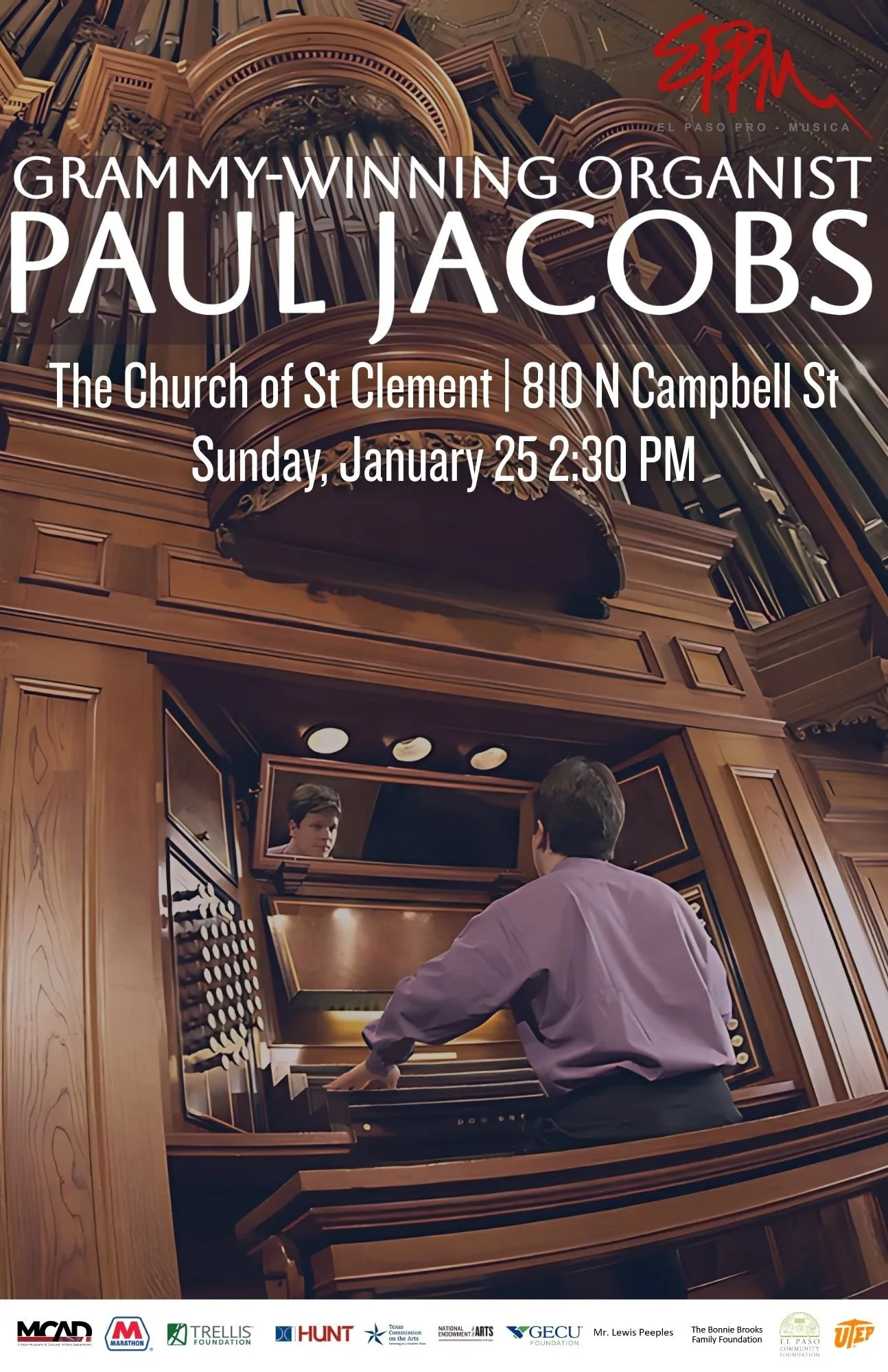 An organist playing a large wooden church pipe organ with multiple pipes.
