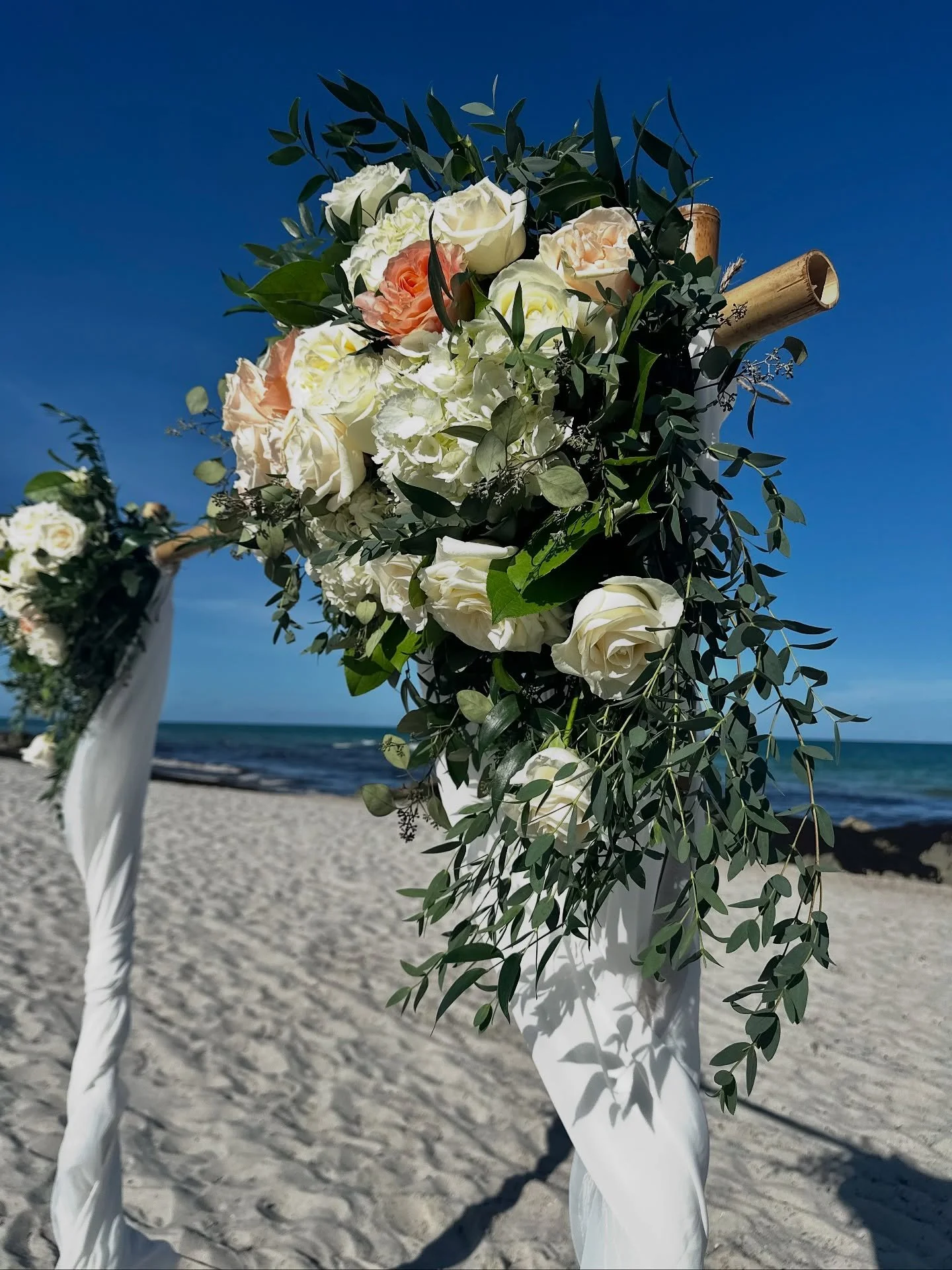 A sunset beach ceremony with a burst of sunset hued roses…we are so excited and honored to have provided bridal florals for this minimony wedding at @palmshotelmiami.