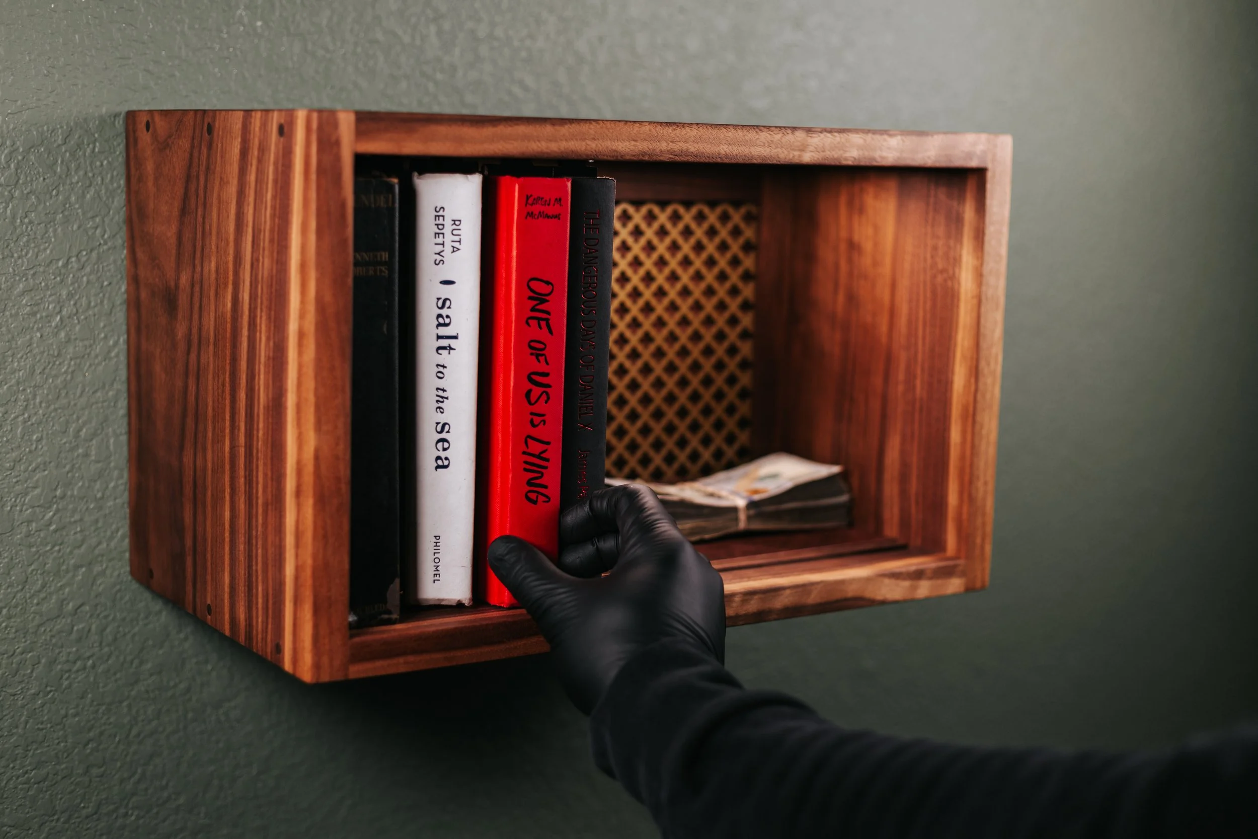 man opening a tambour book safe