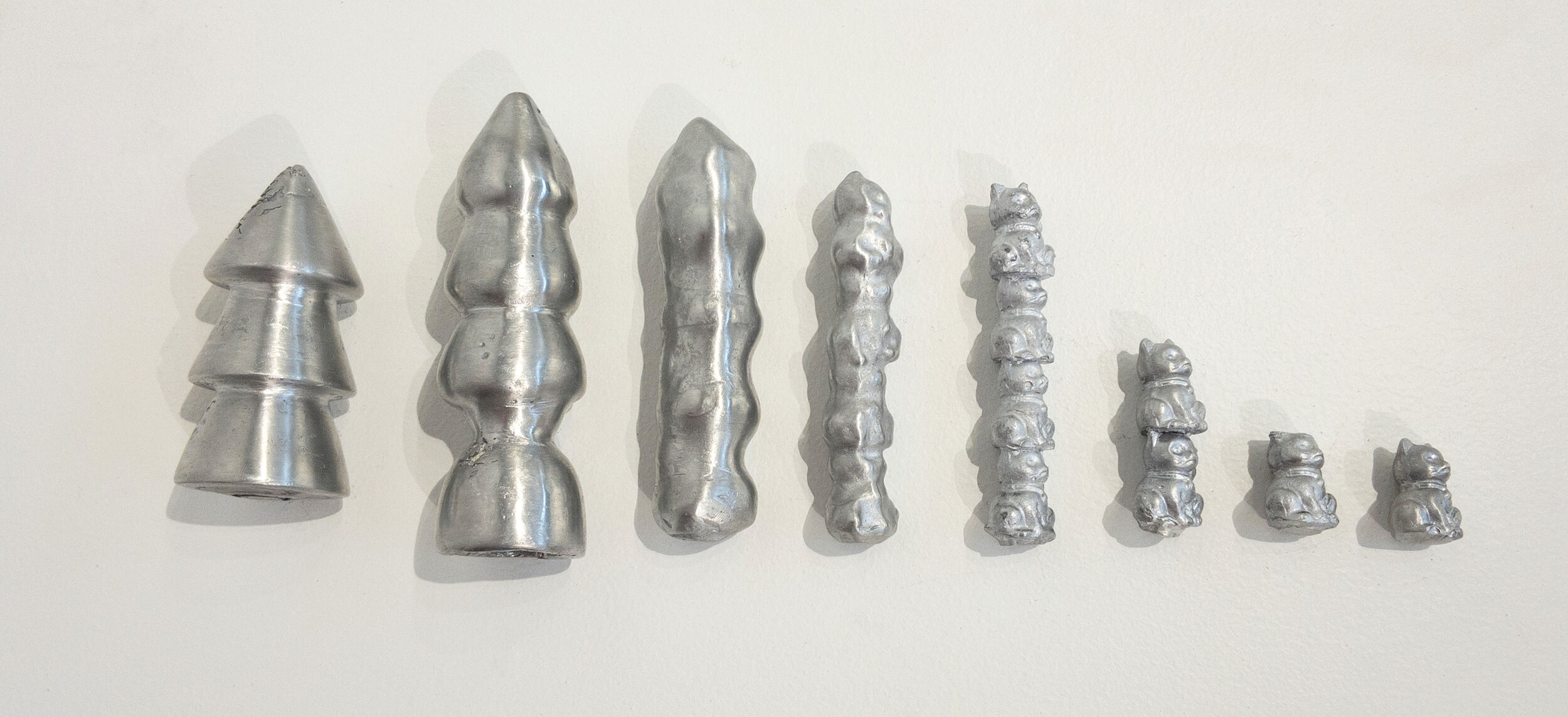 Aluminum Casting: .5~2” x .5~2” x .5~6”; Aluminum; Collaboration with Peyton Follis; October-December 2019;
These eight aluminum castings show the morphing of a pine tree into a cat. The casts were made with ceramic shell and poured on KCAI campus. T