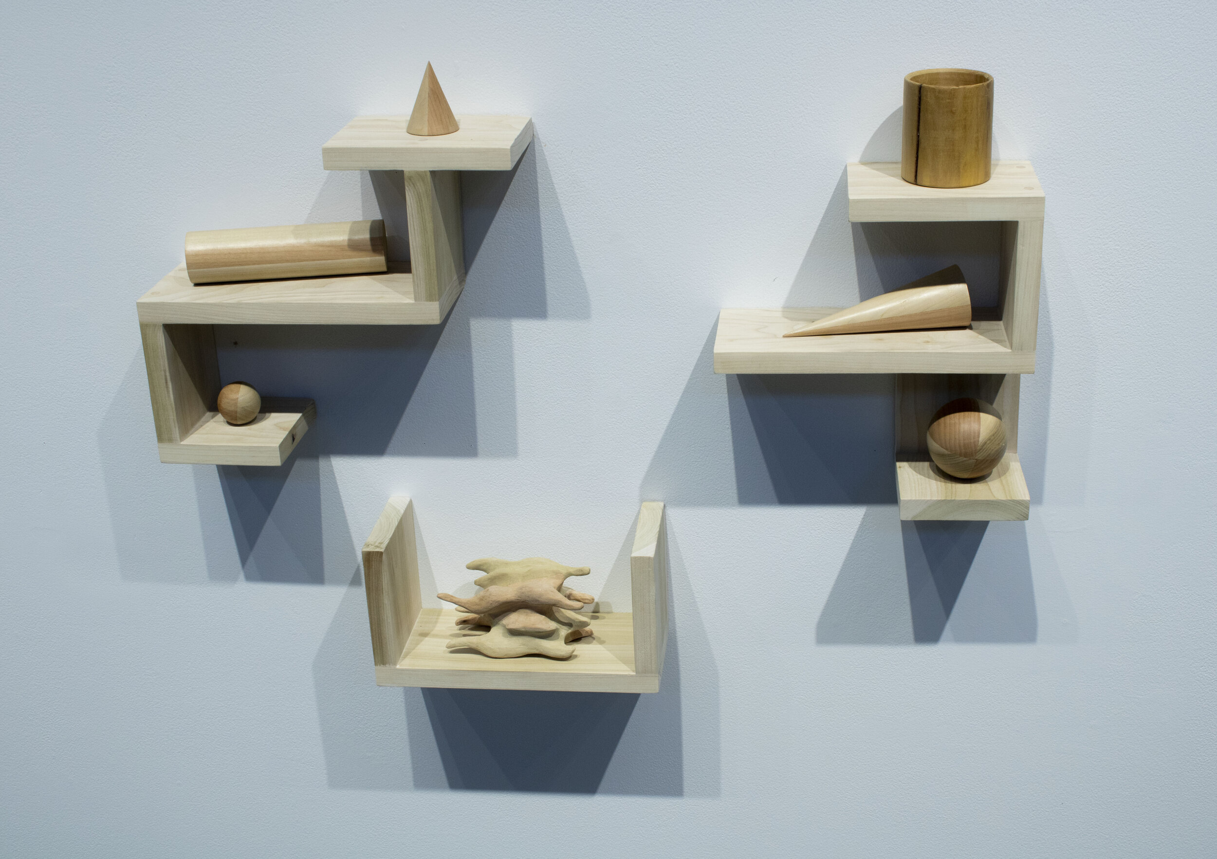 Lathed Shapes and Shelves: 2.5” x 6” x 18”; Wood; October 2019;
Six level and even lathed pieces; two cones, two spheres, one cylinder, and a vessel. Also pictured is one hand-carved piece on the bottom shelf, and three perfectly level shelves. Each