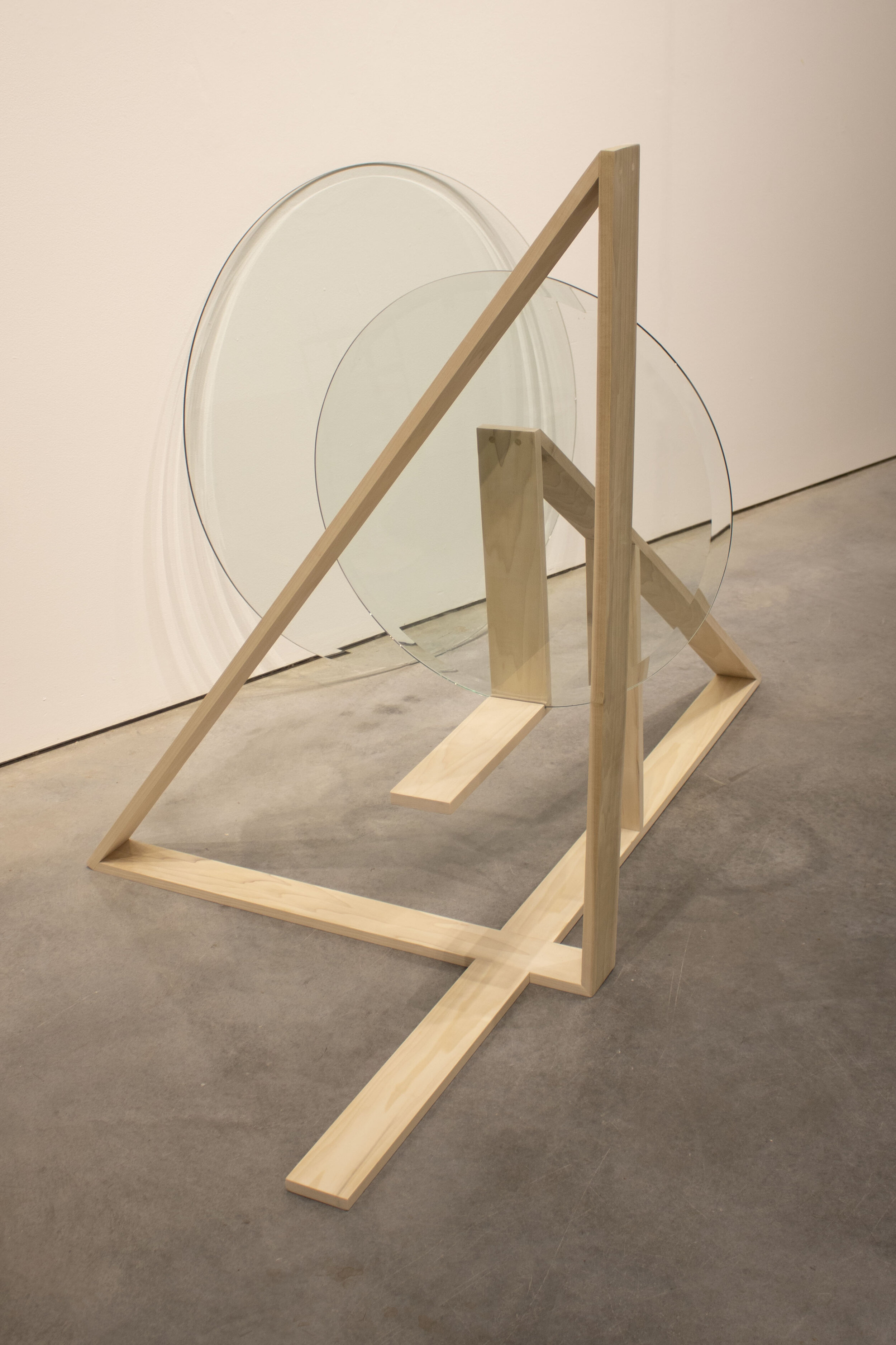 Touching Balance: 4’ x 3’ x 3.5’; Wood, two round glass panels; September 2019;
The prompt for this sculpture was to make a structure that could hold 25 pounds of weight. Two intersecting triangles existing on different planes are used to hold up a
