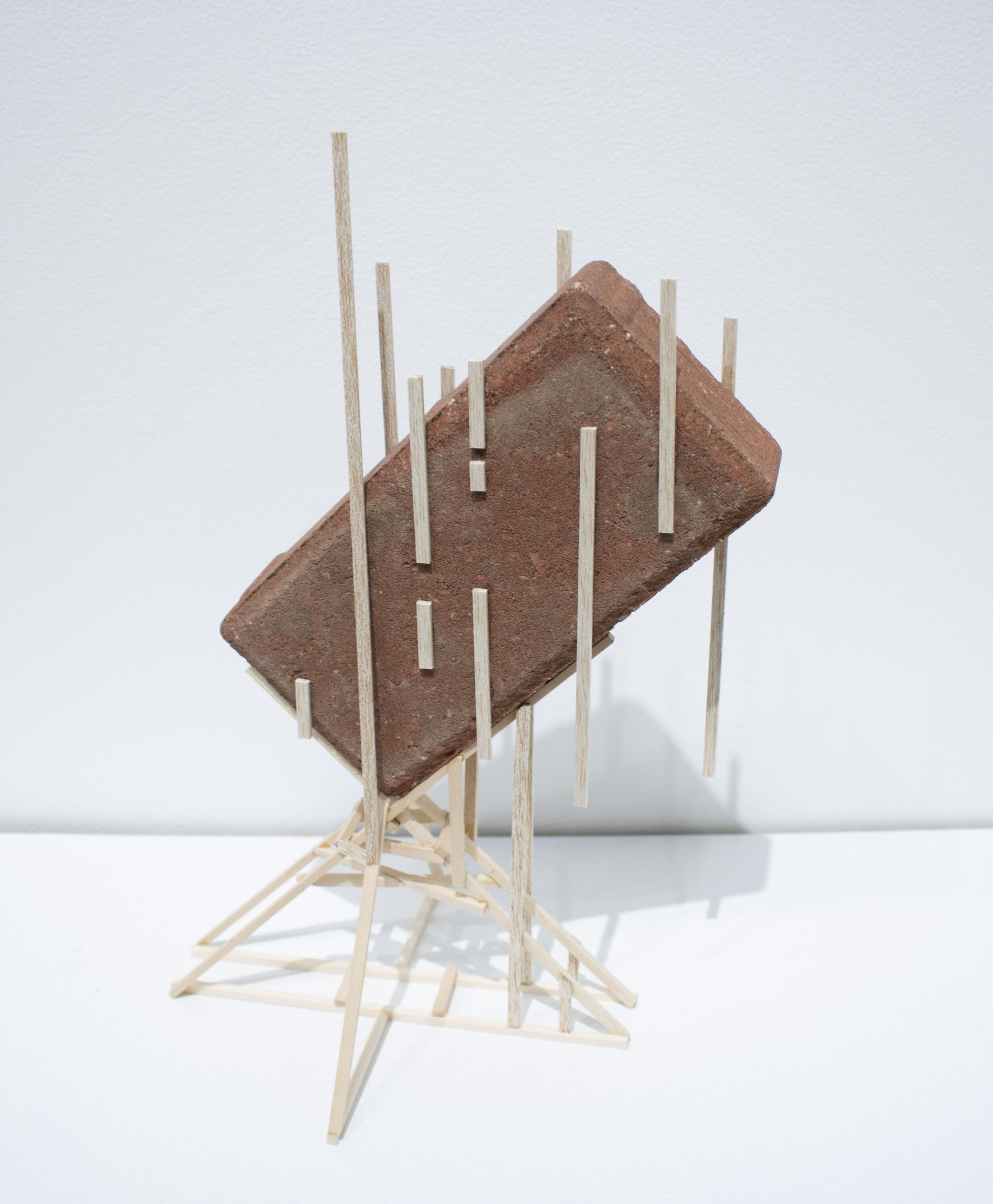 Levitating Brick: 7” x 6” x 12”; Standard size brick, balsa wood; September 2019;
The prompt for this piece was to use balsa wood to make a brick stand off of a table. I took inspiration from Roman architecture to create an armature similar to that o