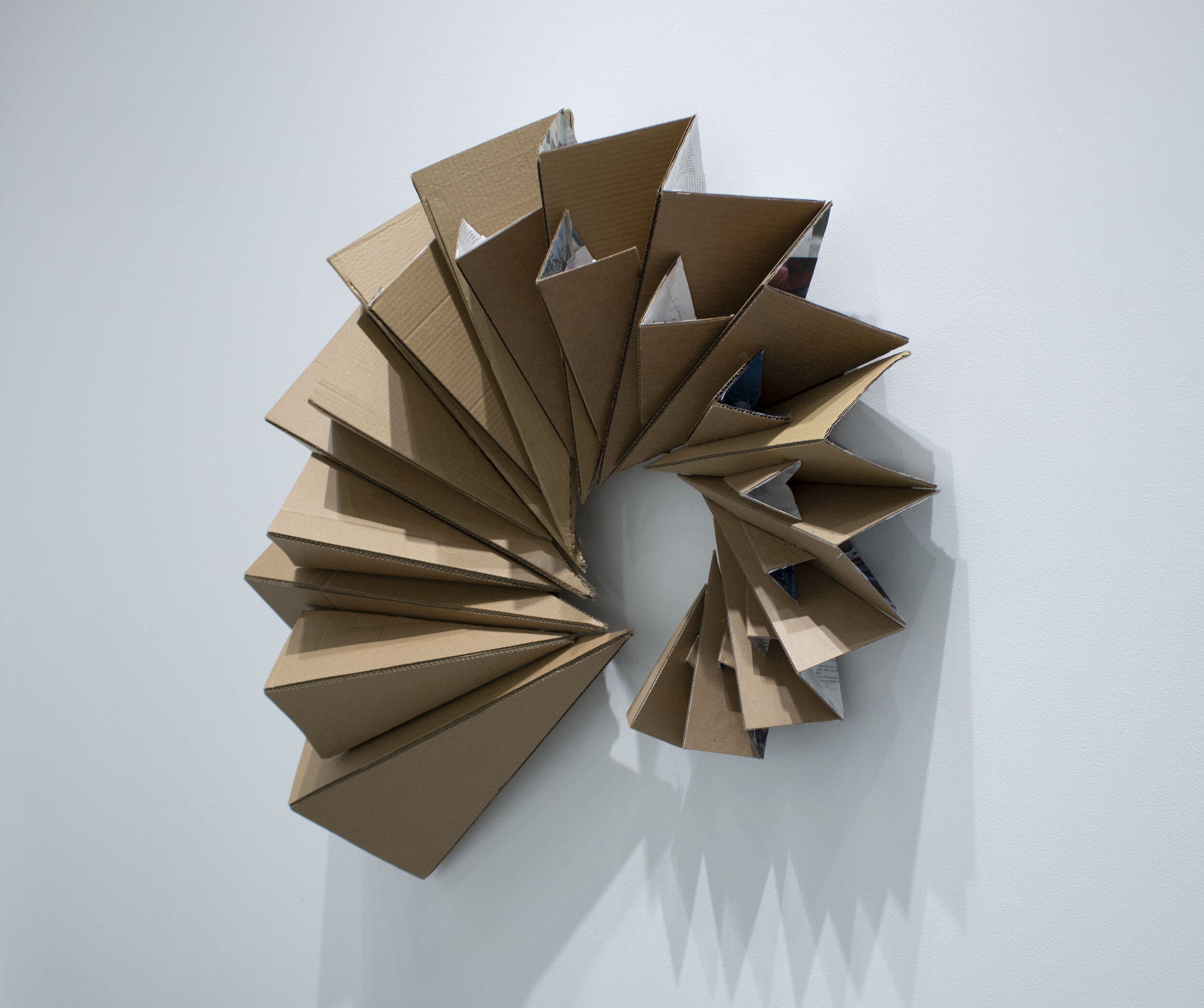 Cardboard Spiral: 4’ x 9” x 3’; Cardboard and magazine scraps; September 2019;
For this project we were to choose one of the three paper sculptures to push further and recreate out of another material. I choose the paper spiral to recreate at a large