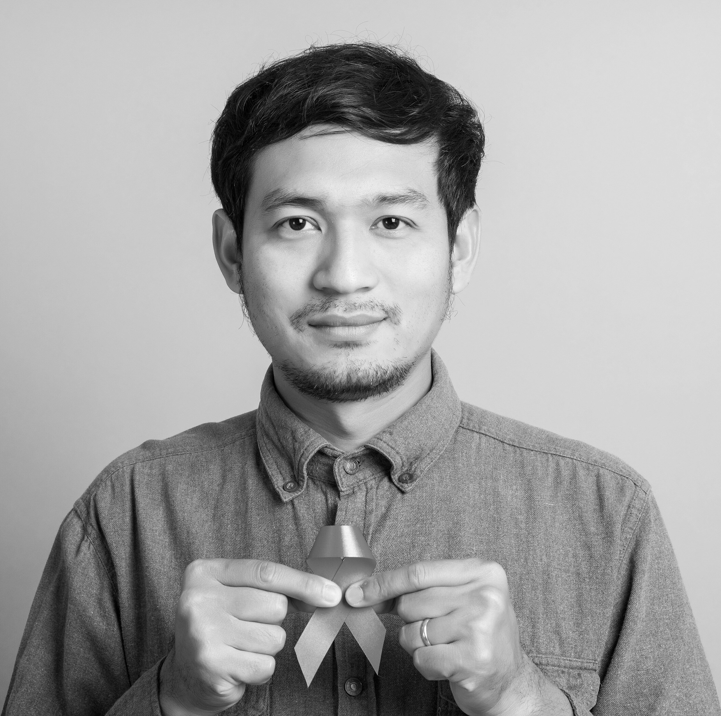 asian_man_holding_ribbon.jpg