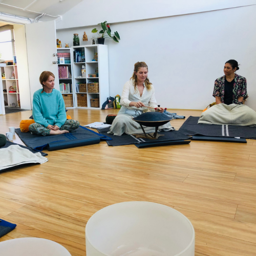 Workshop participant exploring a Rav Vast hand pan to introduce herself to the group.