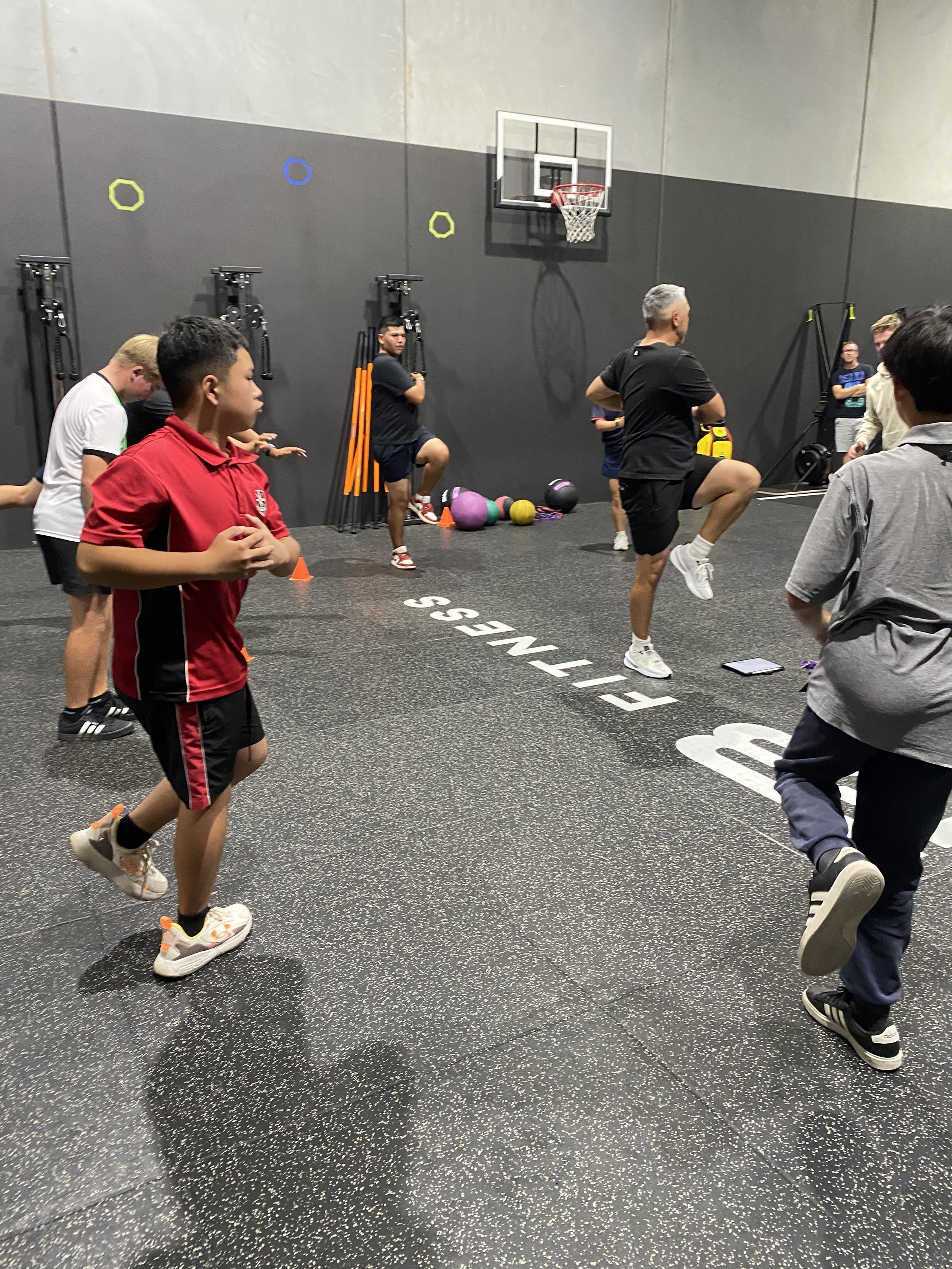 group of kids following a junior golf class