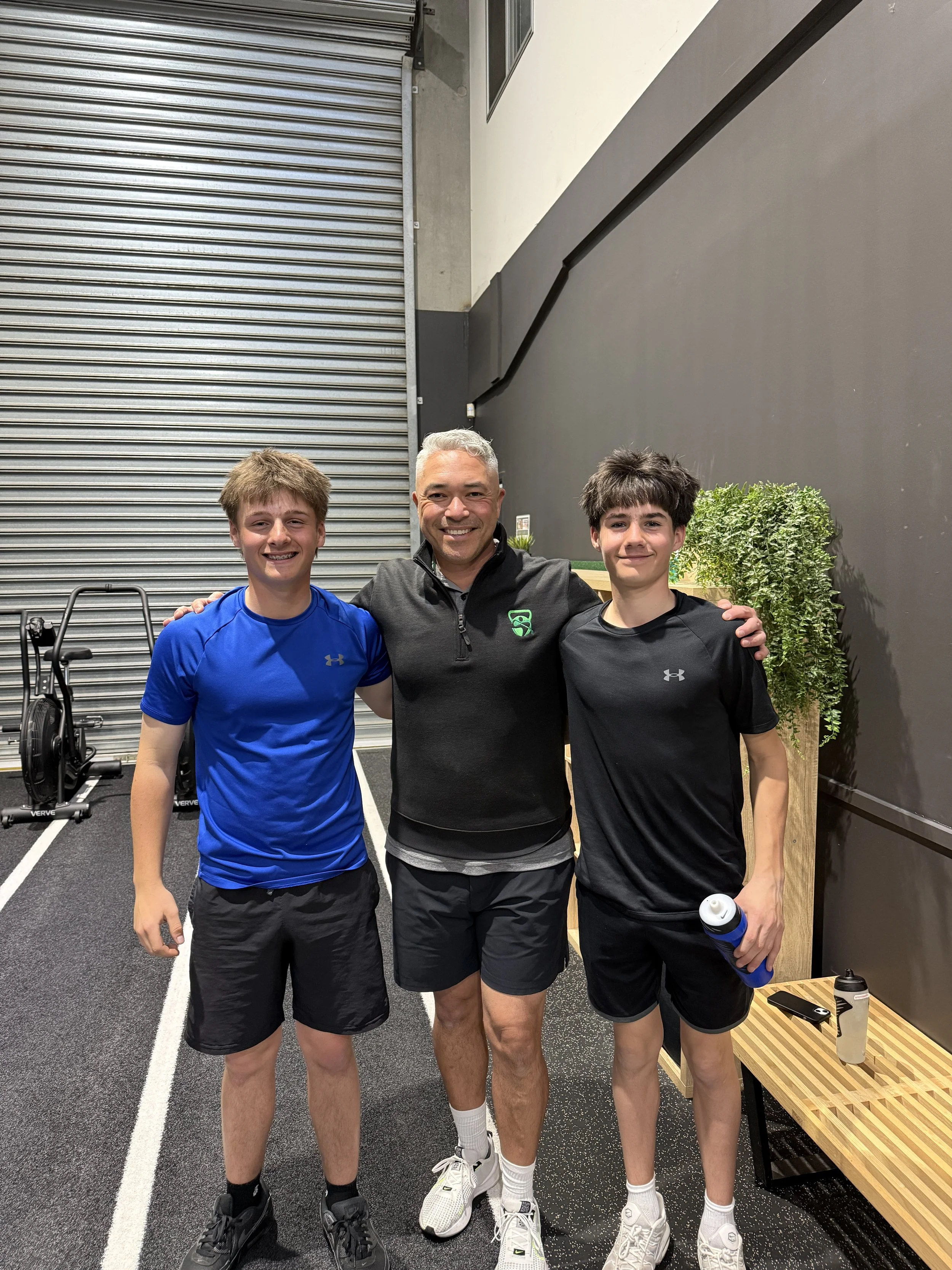 Young golfers arm in arm with their performance coach