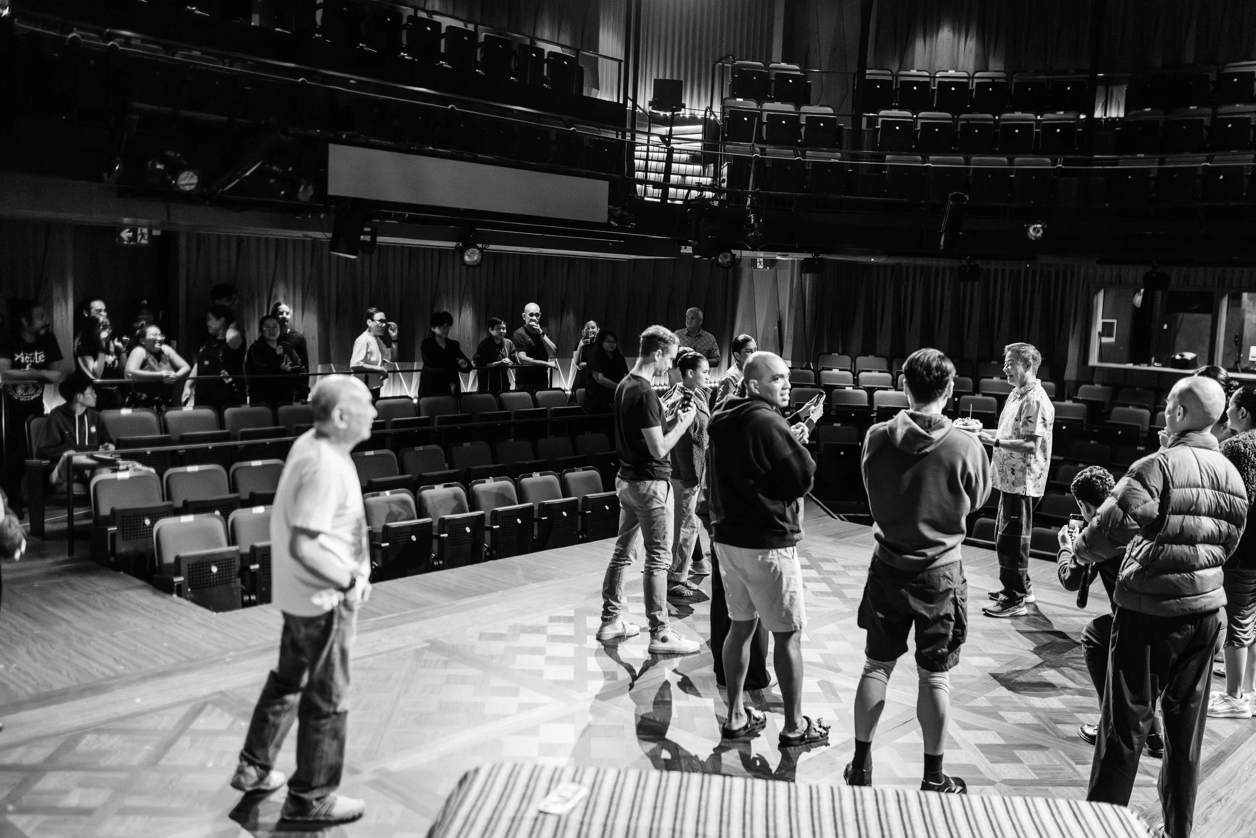 The Company of Hotel gather on stage to celebrate Director Ivan Heng's birthday.