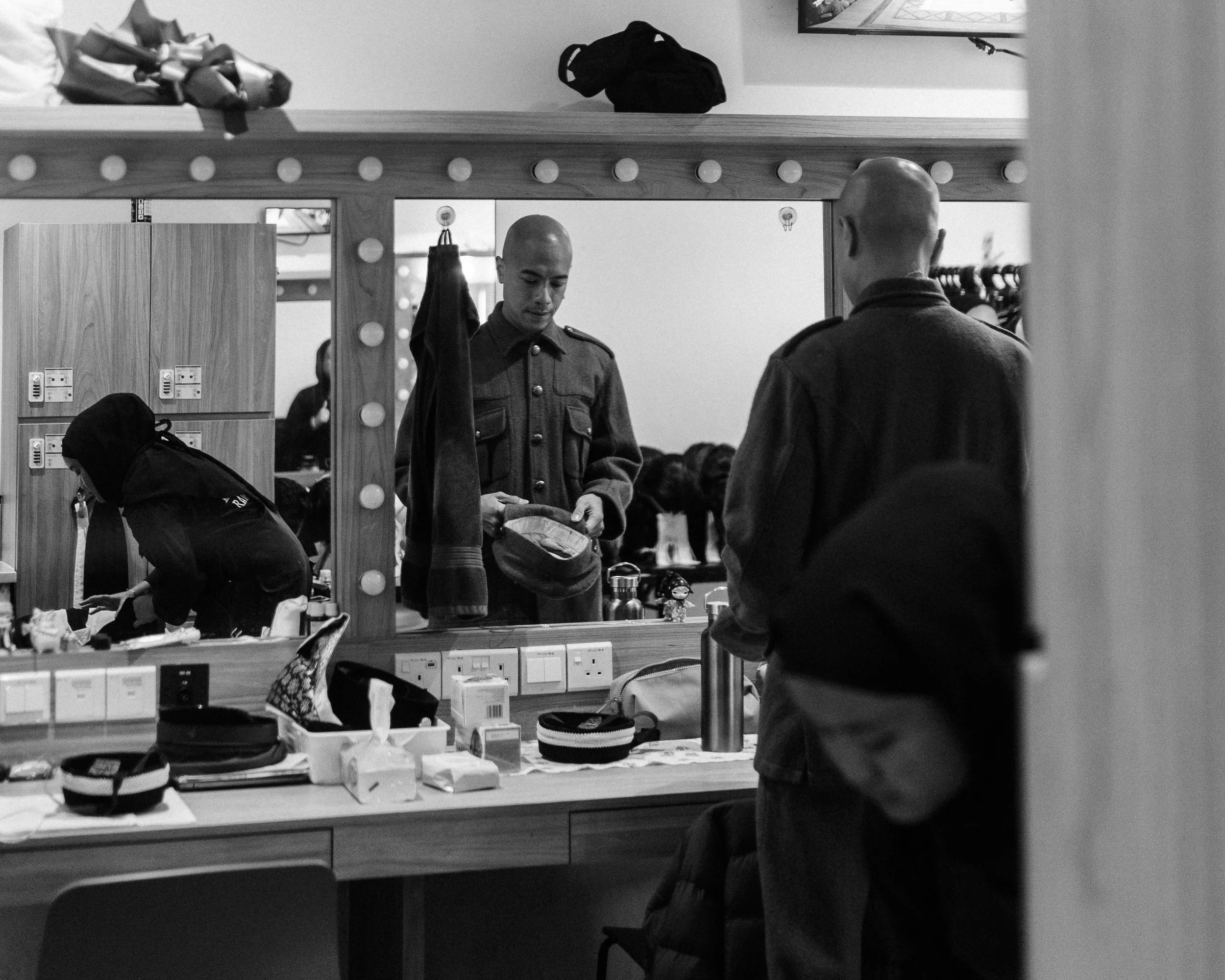 Brendon Fernandez in the dressing room, cap in hand, dressed as the Ghost of a British Soldier from 1935.