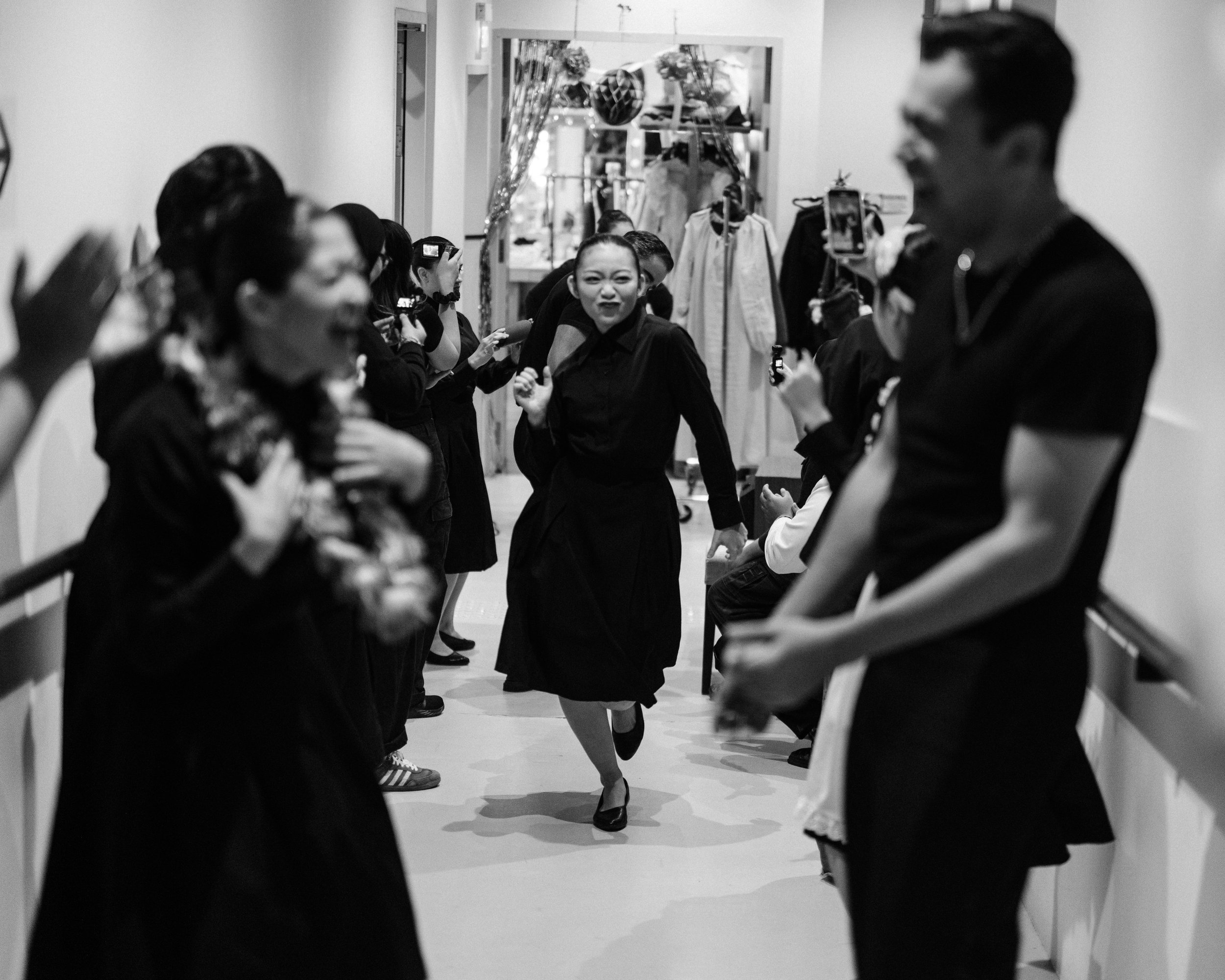 Coco Wang Ling strides down the hallway, ready to enter at the top of Part 1.