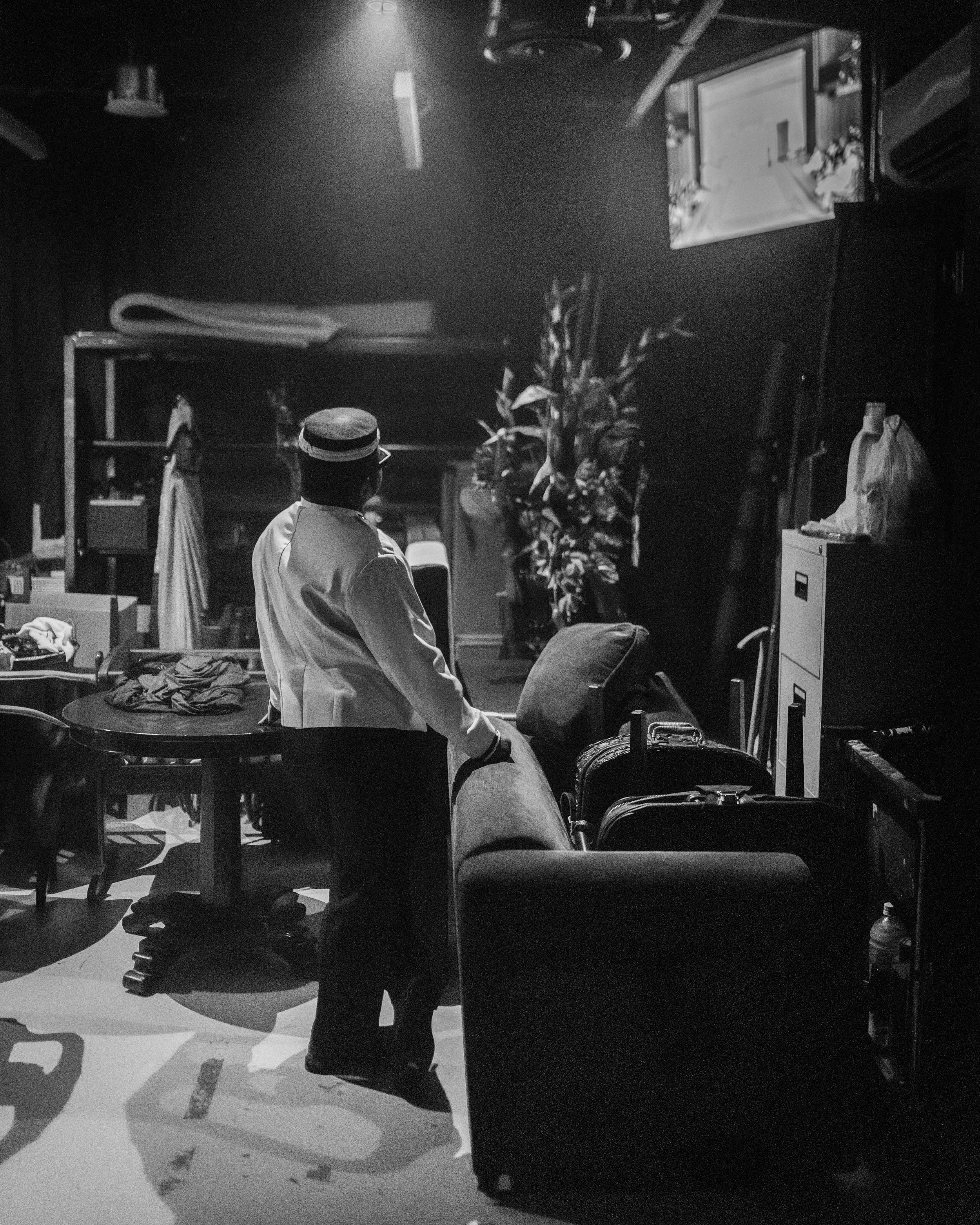 Stage Assistant Ali Mazrin prepares for a set change while watching the show on the monitor backstage.