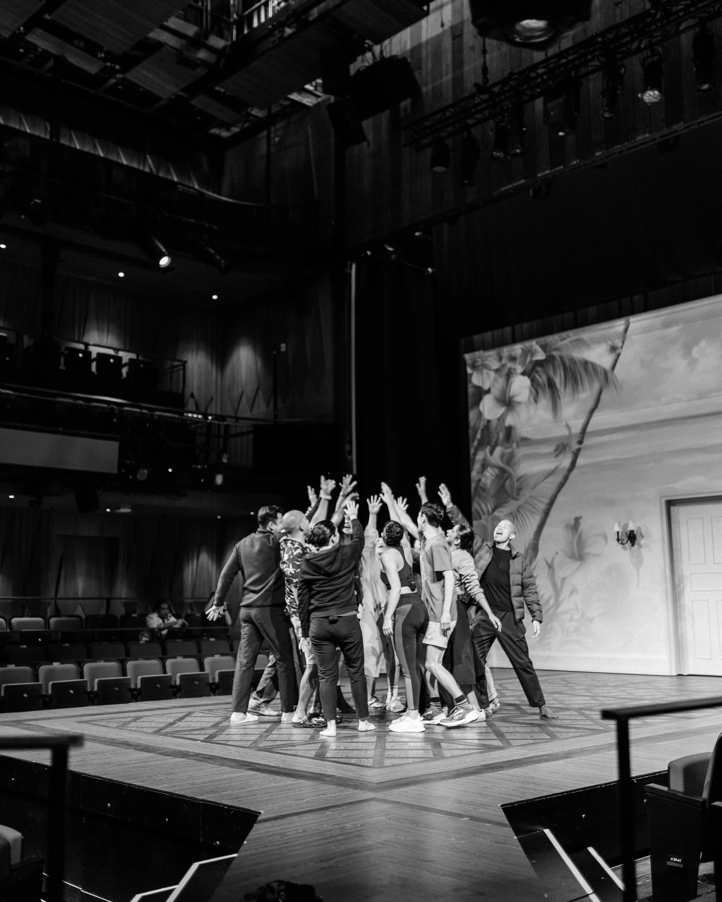 The Cast of Hotel on stage, giving a final cheer before the final performance.