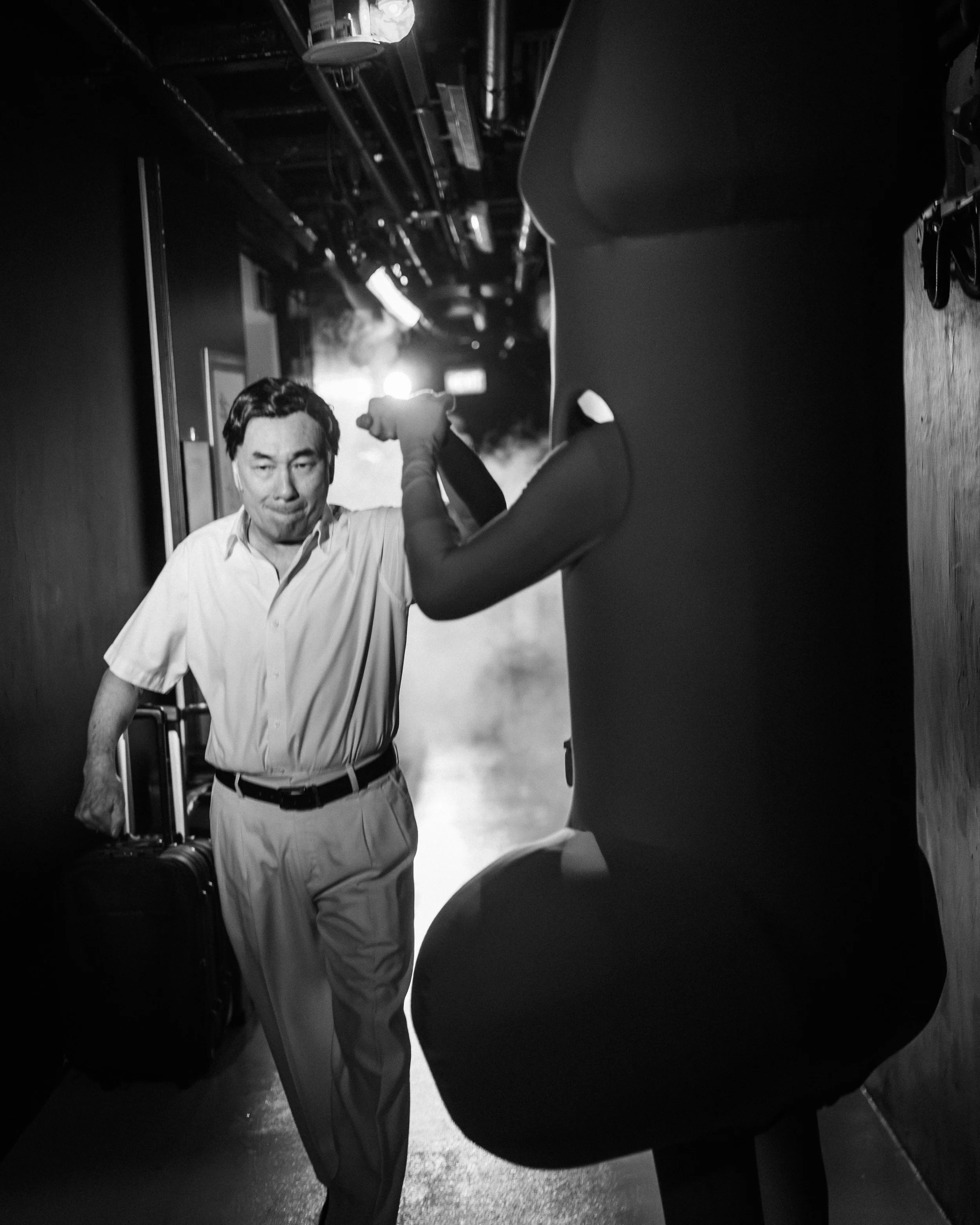 Lim Kay Siu (dressed as Old Man) fist bumps Ghafir Akbar (dressed as Penis) backstage after exiting from Scene 1975.