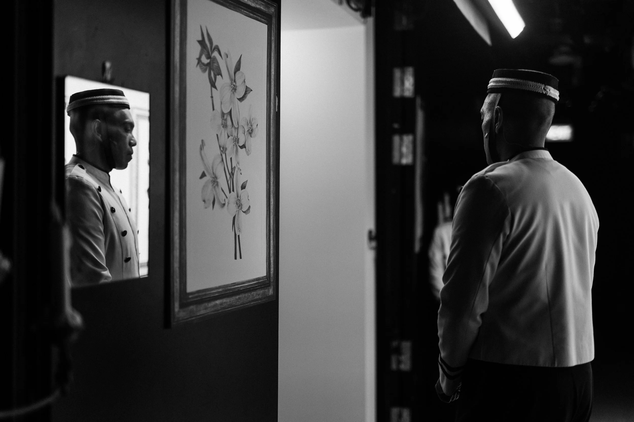 Dwayne Lau waits to enter as the bellboy Dawood in Scene 1915.