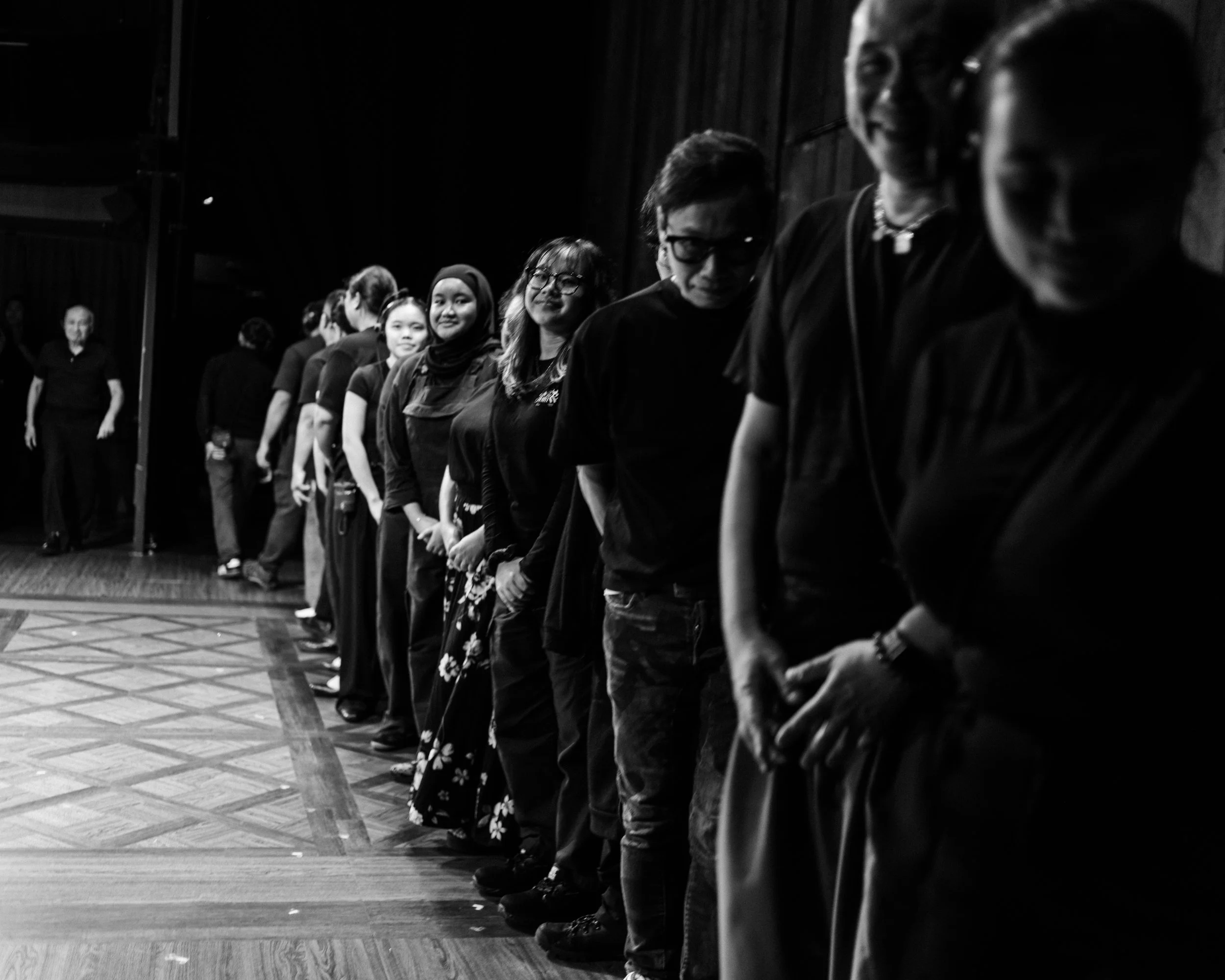 Members of the Crew, Wardrobe, Hair, and Makeup teams gather on stage to take their bow at end of the show.
