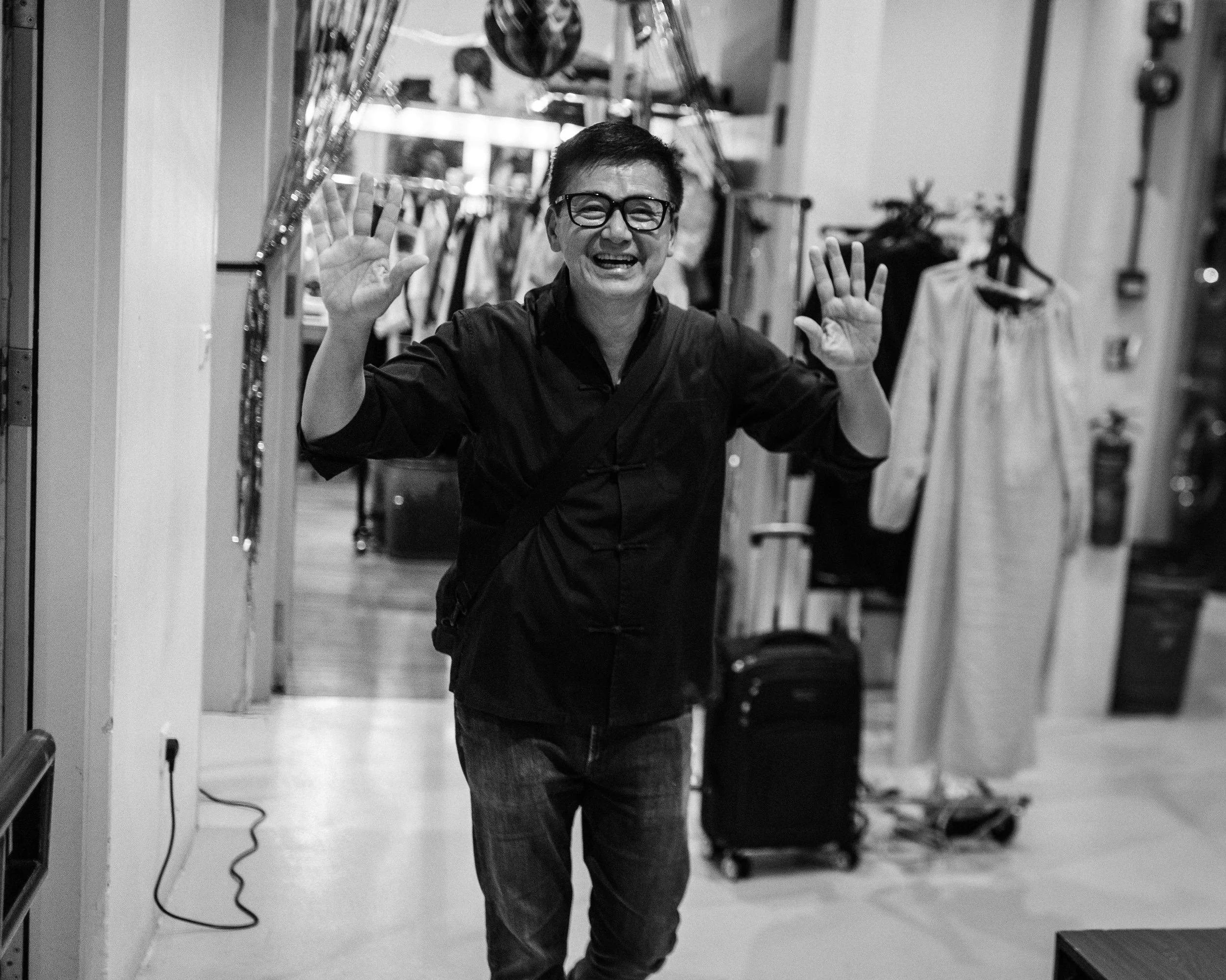 Director Glen Goei waves hello backstage.