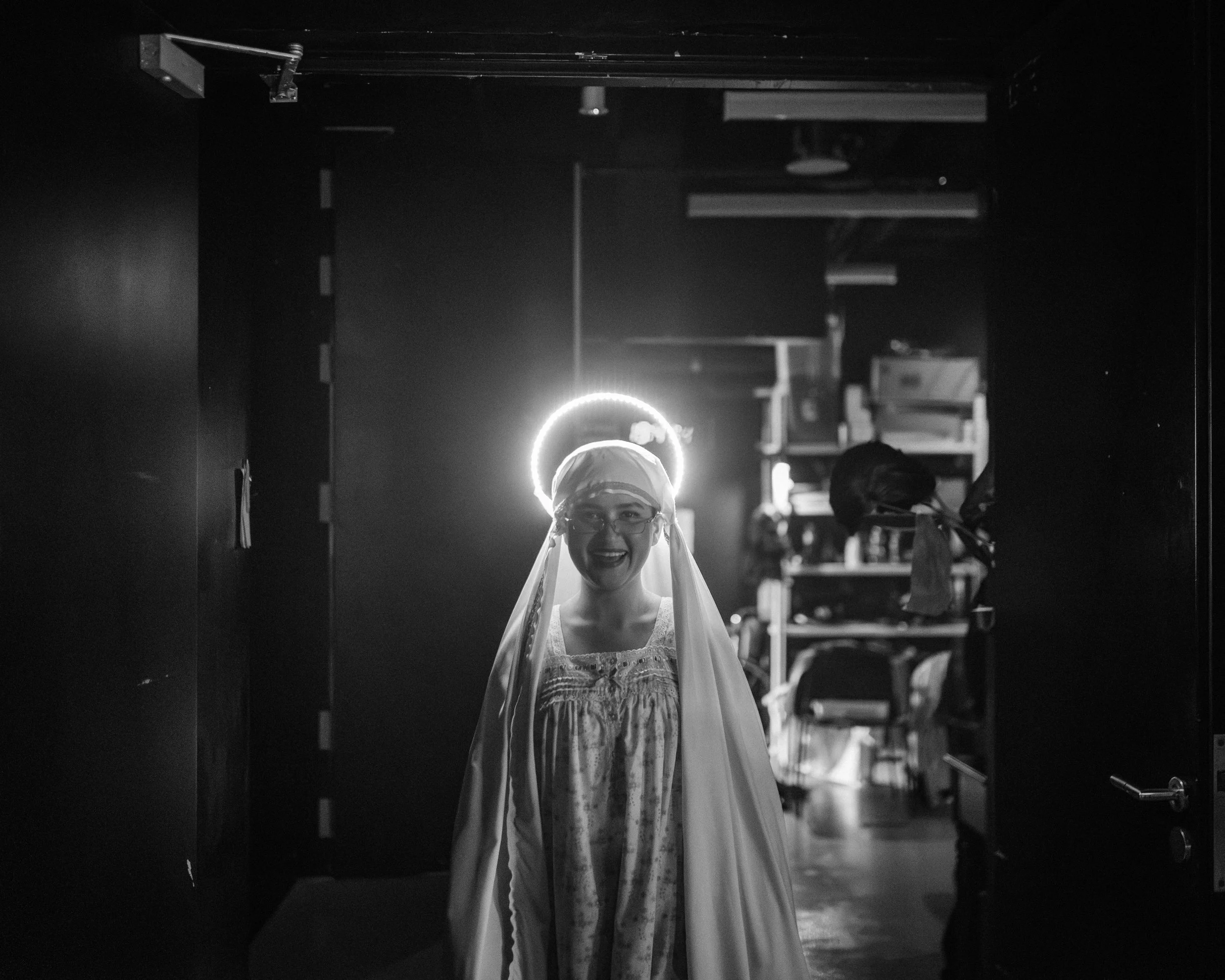 Rebecca Ashley Dass, with light-up halo, in costume as Mary Tessensohn / Mother Mary from Scene 1975.