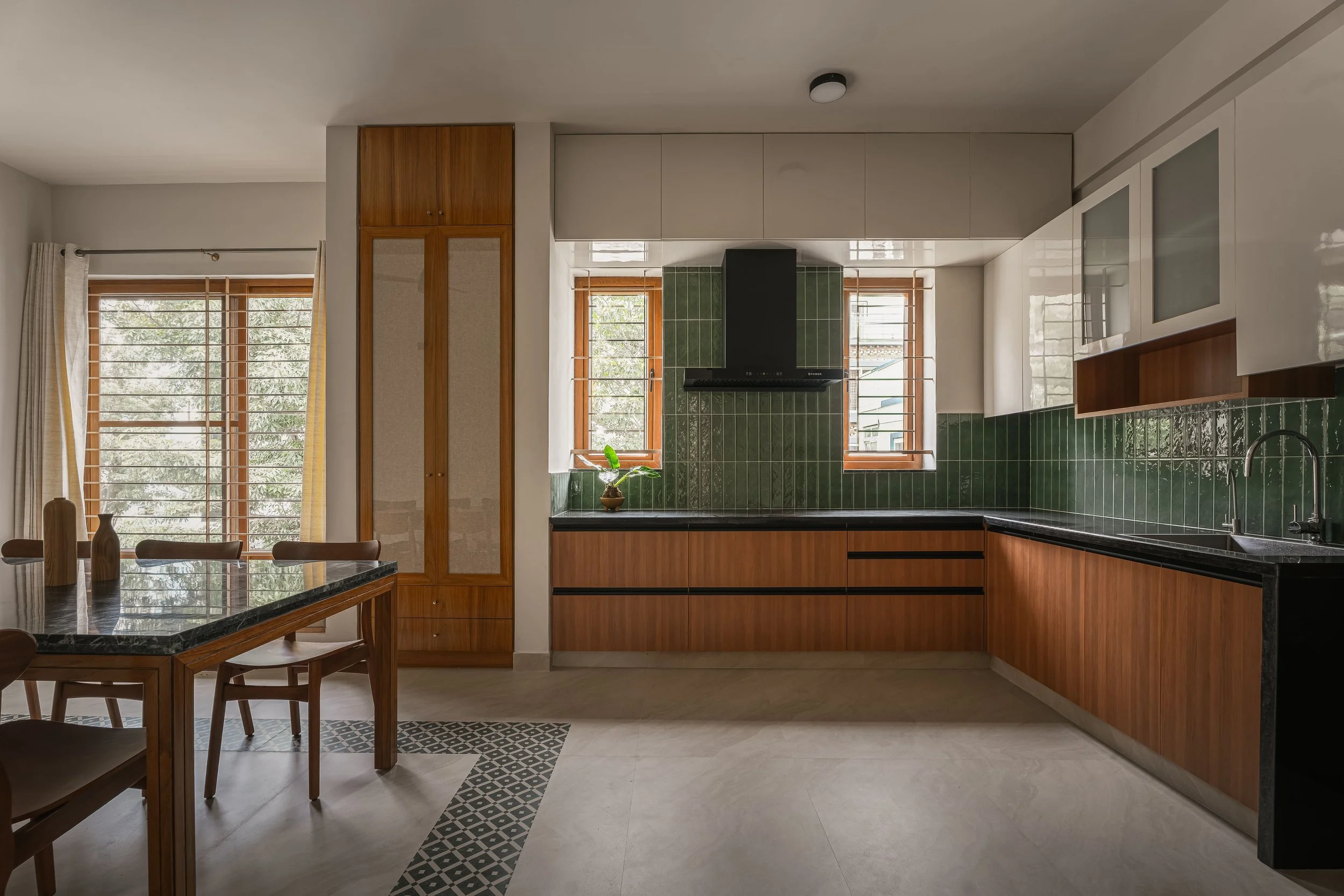 Kitchen with green tile and the dining table beside it