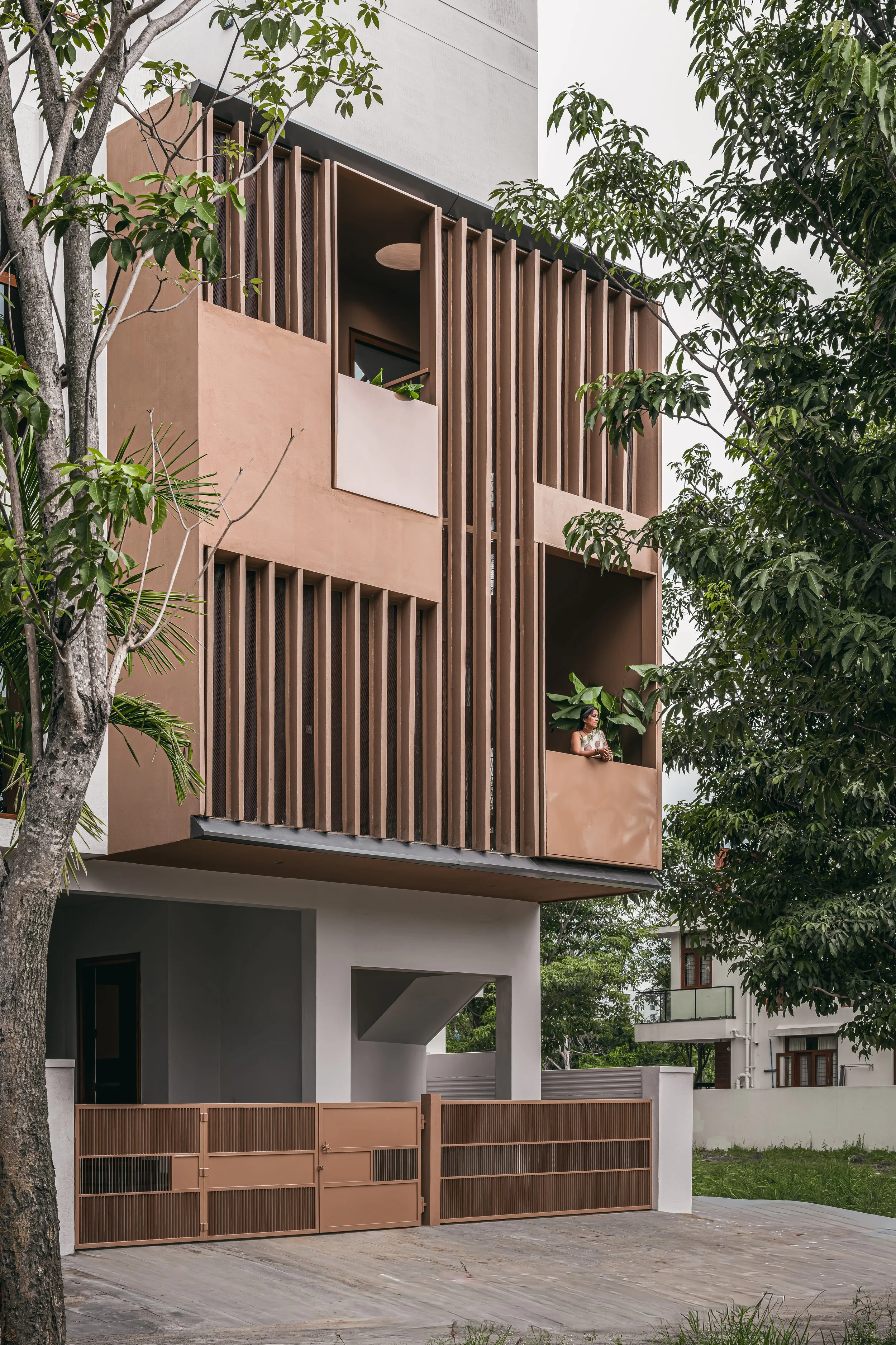 The west façade from the street: copper screens over the gate