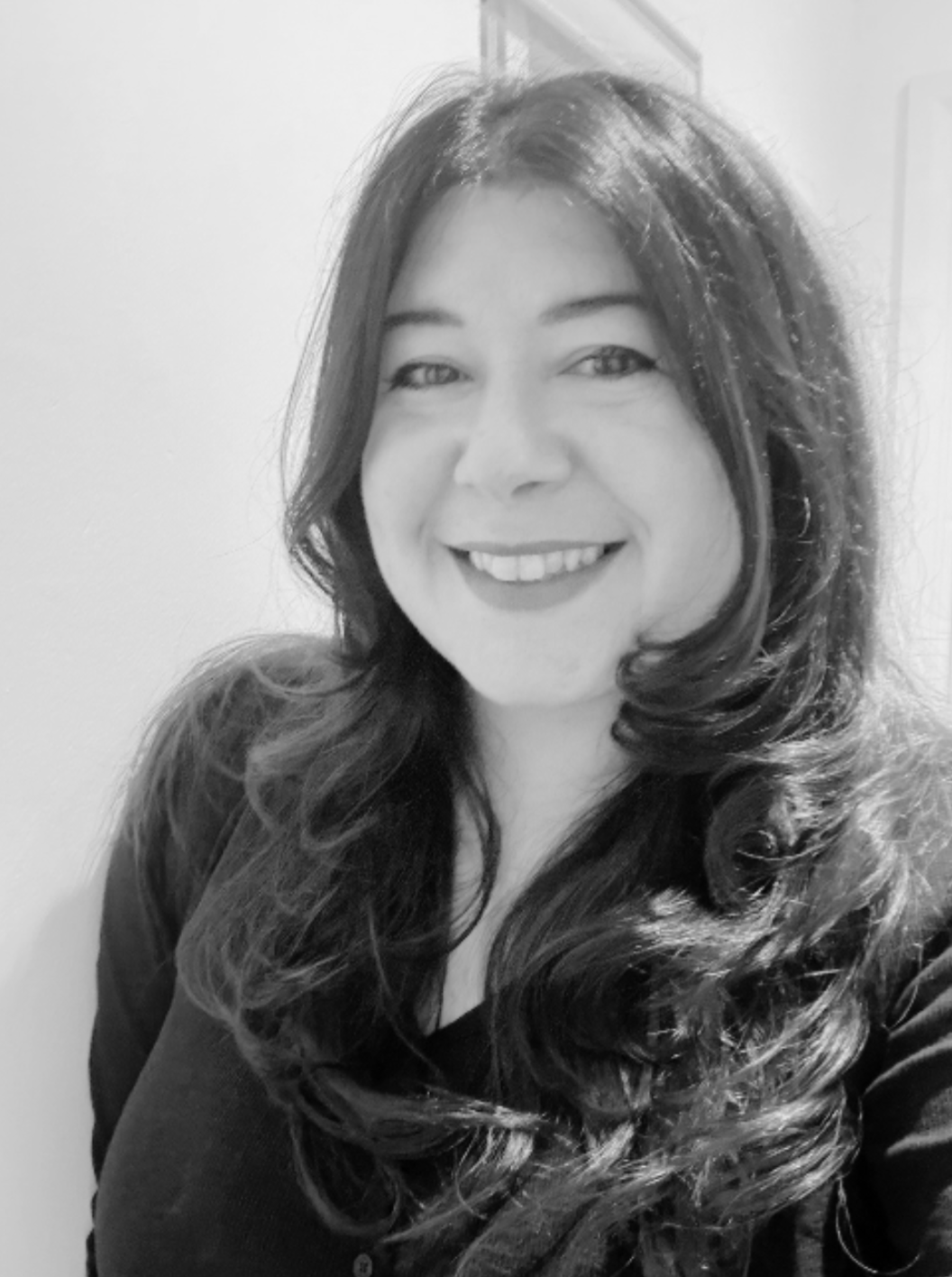 Woman with long dark hair smiling