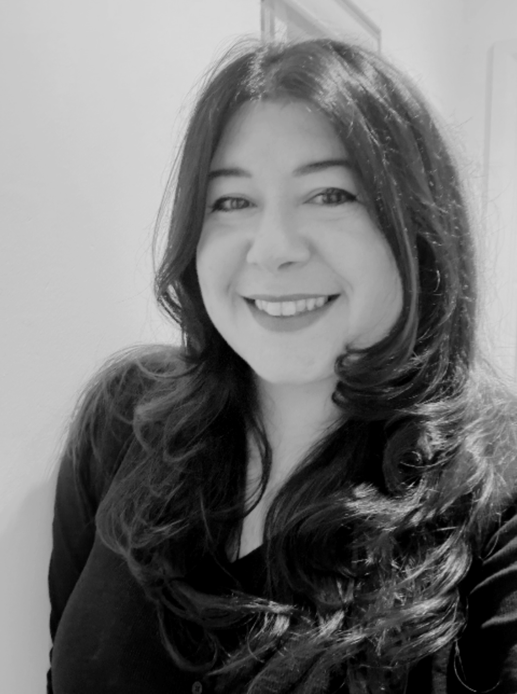 Woman with long dark hair smiling