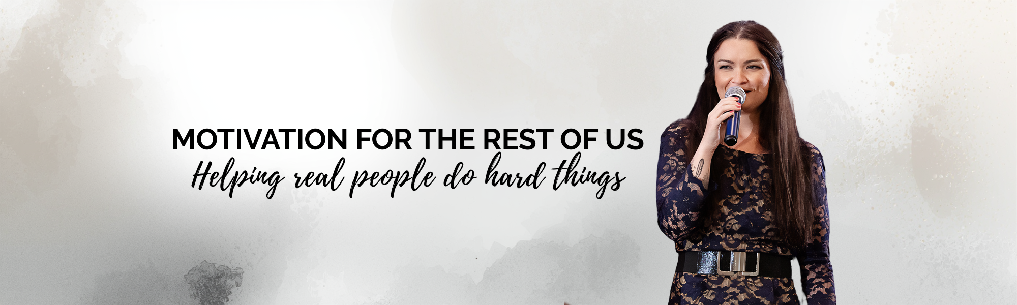 A woman holding a microphone and smiling, standing beside text that reads "Motivation for the Rest of Us" and "Helping real people do hard things".