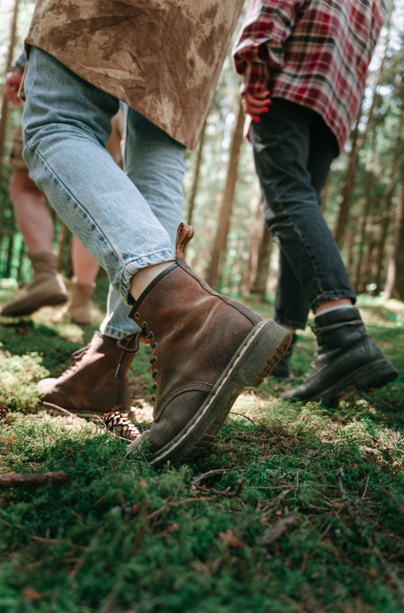 A close-up of hiking boots walking through the woods, representing the active, grounding approach to overcoming anxiety and stress with Daybreak Therapy in Mt. Juliet.