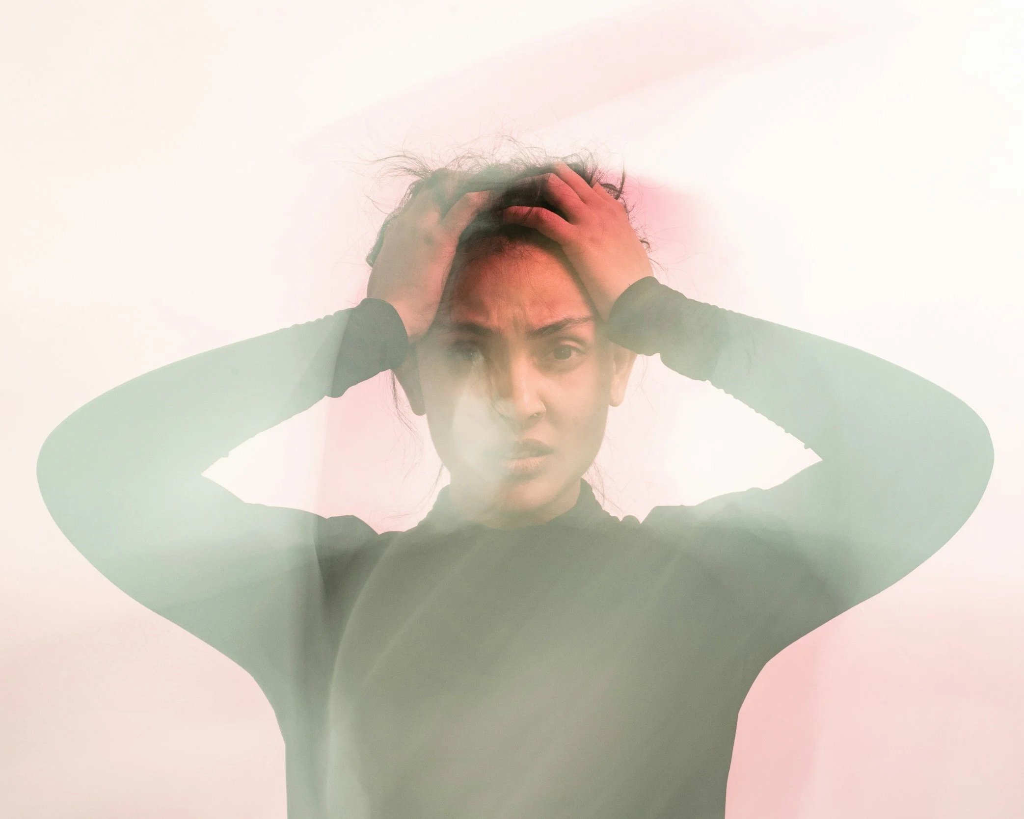 A visual representation of a woman feeling overwhelmed and holding her head, highlighting the specialized anxiety and trauma therapy available through Daybreak Therapy's online telehealth services.