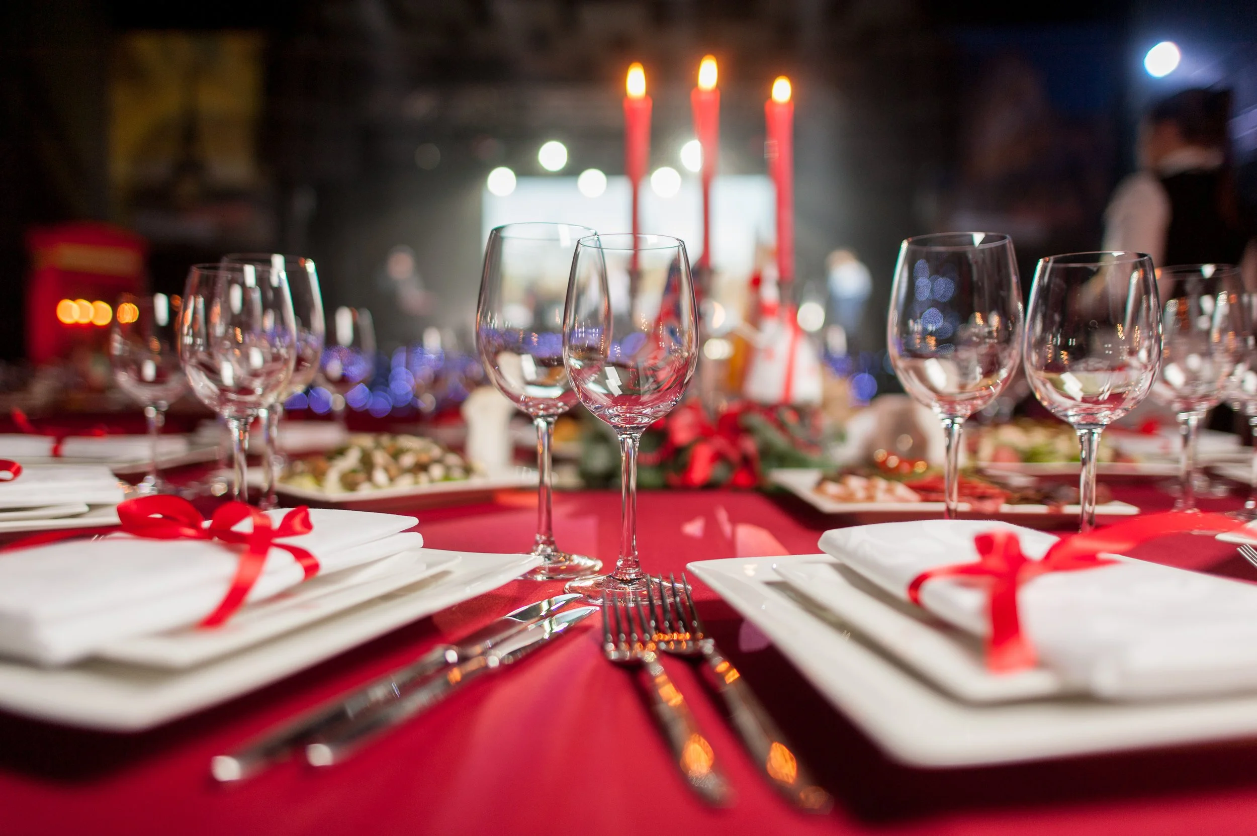 micro small wedding table food place setting with red and candles and catering glasses