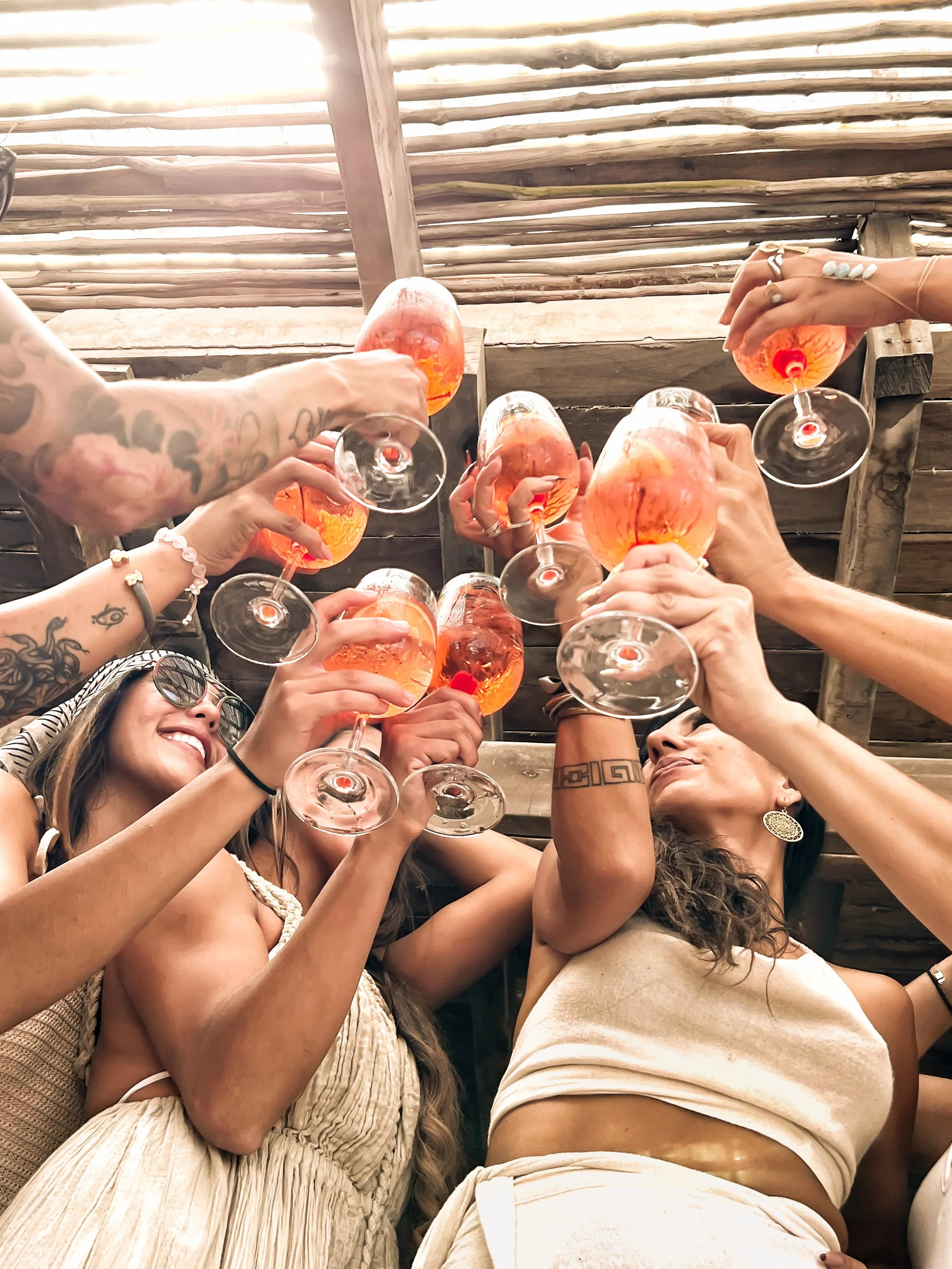 An image of retreat attendees toasting to another beautiful day of fitness and wellness at Amansala Resort in Tulum, Mexico.