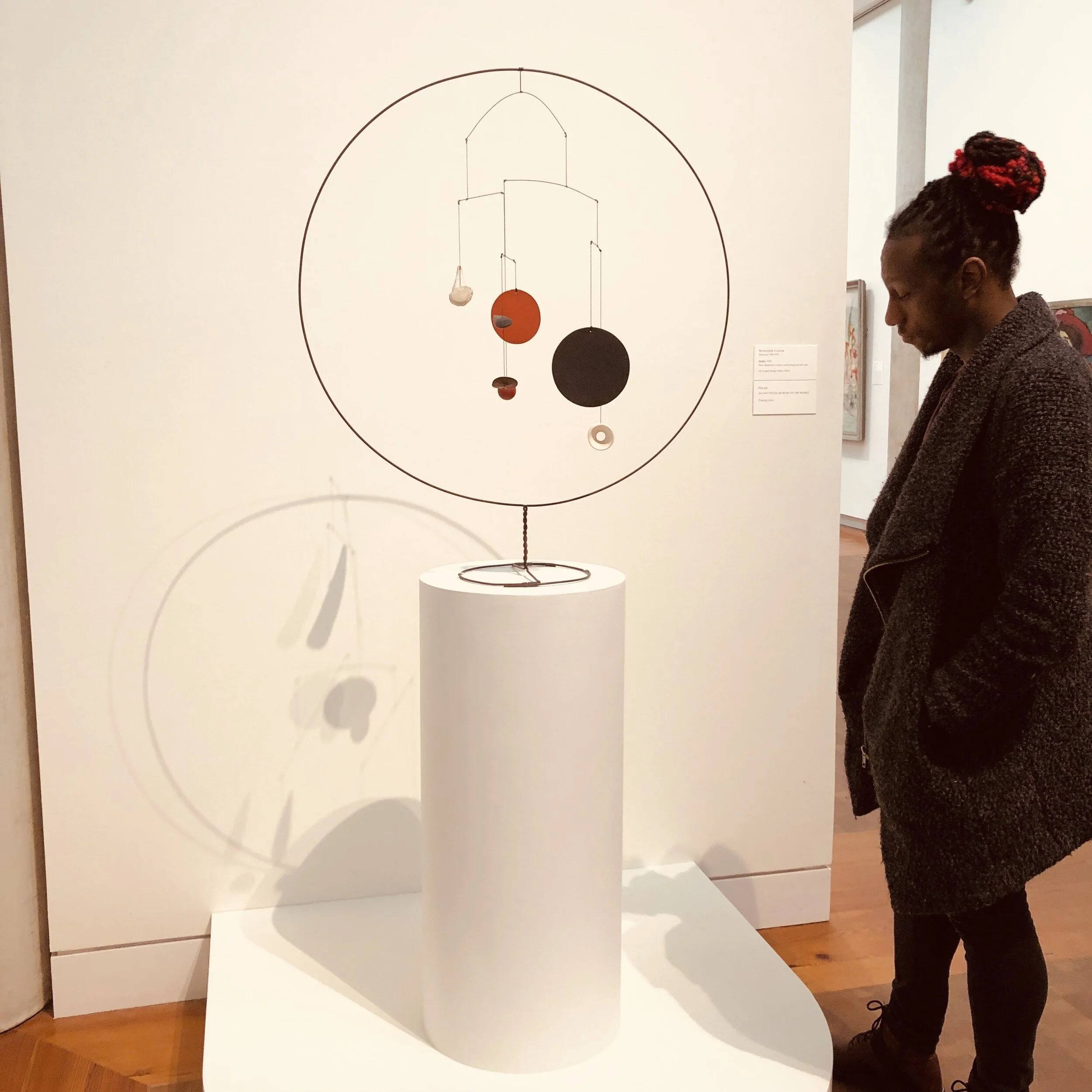 My son looking at Alexander Calder's Mobile, 19S34 (sheet aluminum, ceramic, wood, string and steel wire)