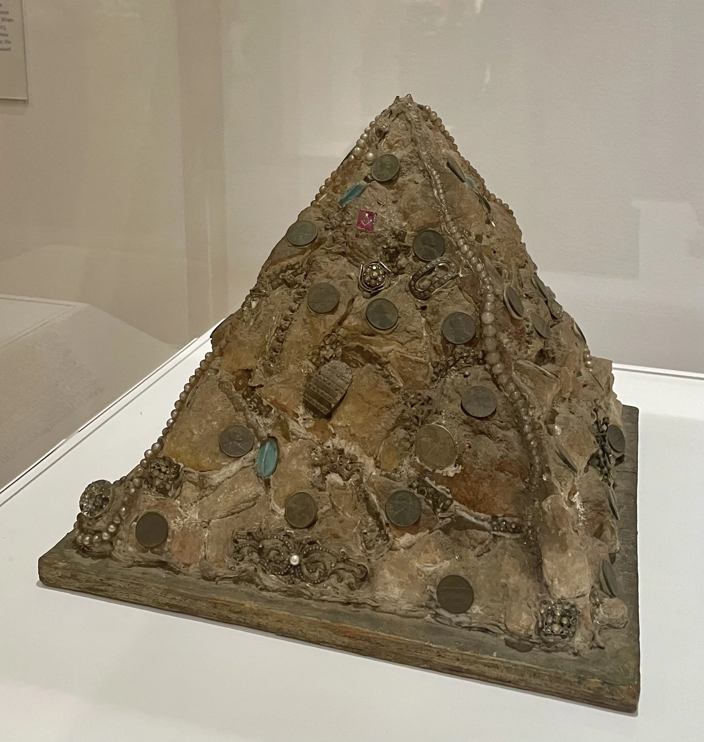 Eldren M. Bailey, Pyramid, 1970s. Concrete, plastic beads, pennies. jewelry.buttons and wood.