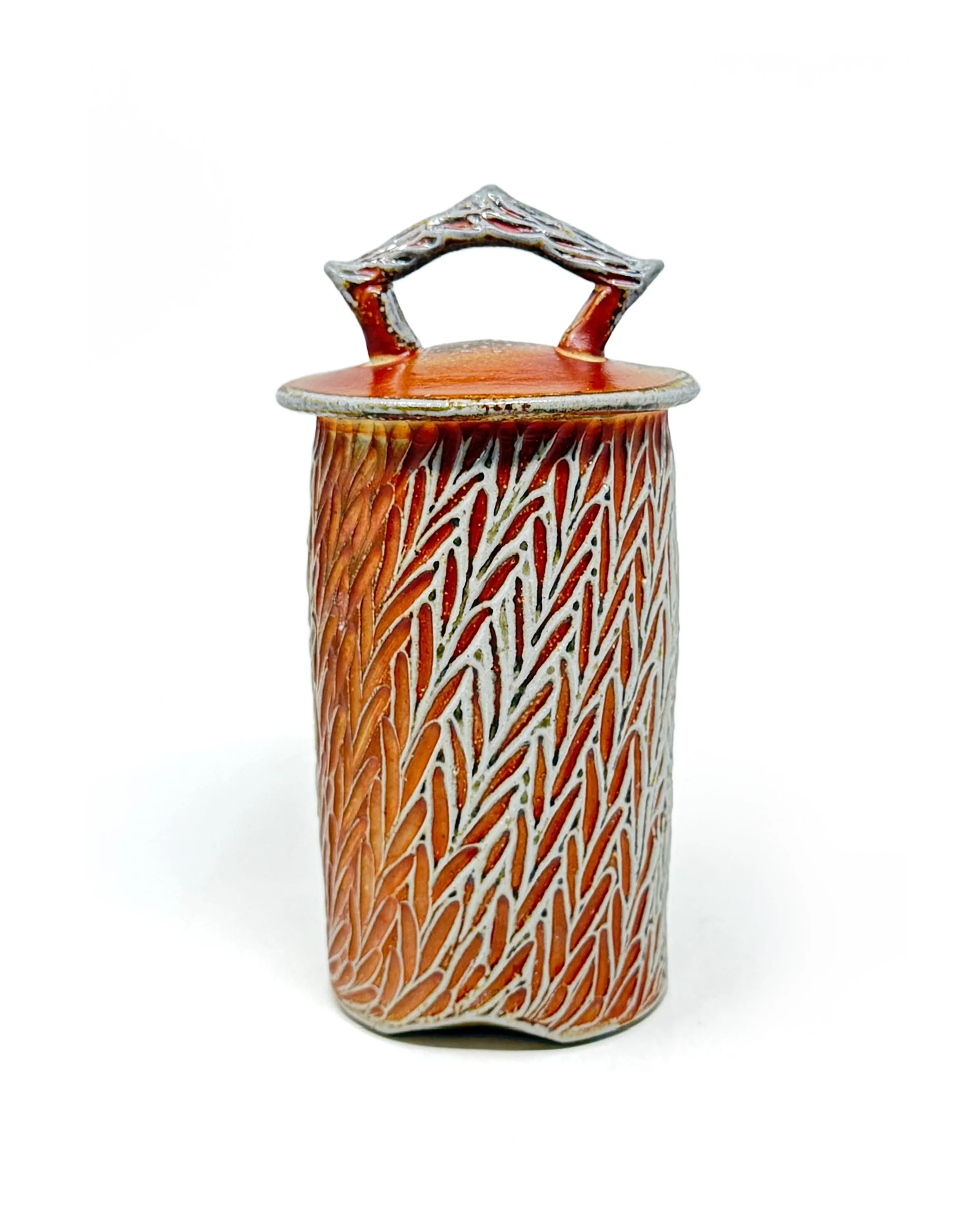 Joy Tanner • 
Carved Jar • 
Soda-glazed stoneware, wheel-thrown and carved • 
9.”5  x 5” x 5” • 
$150 value


